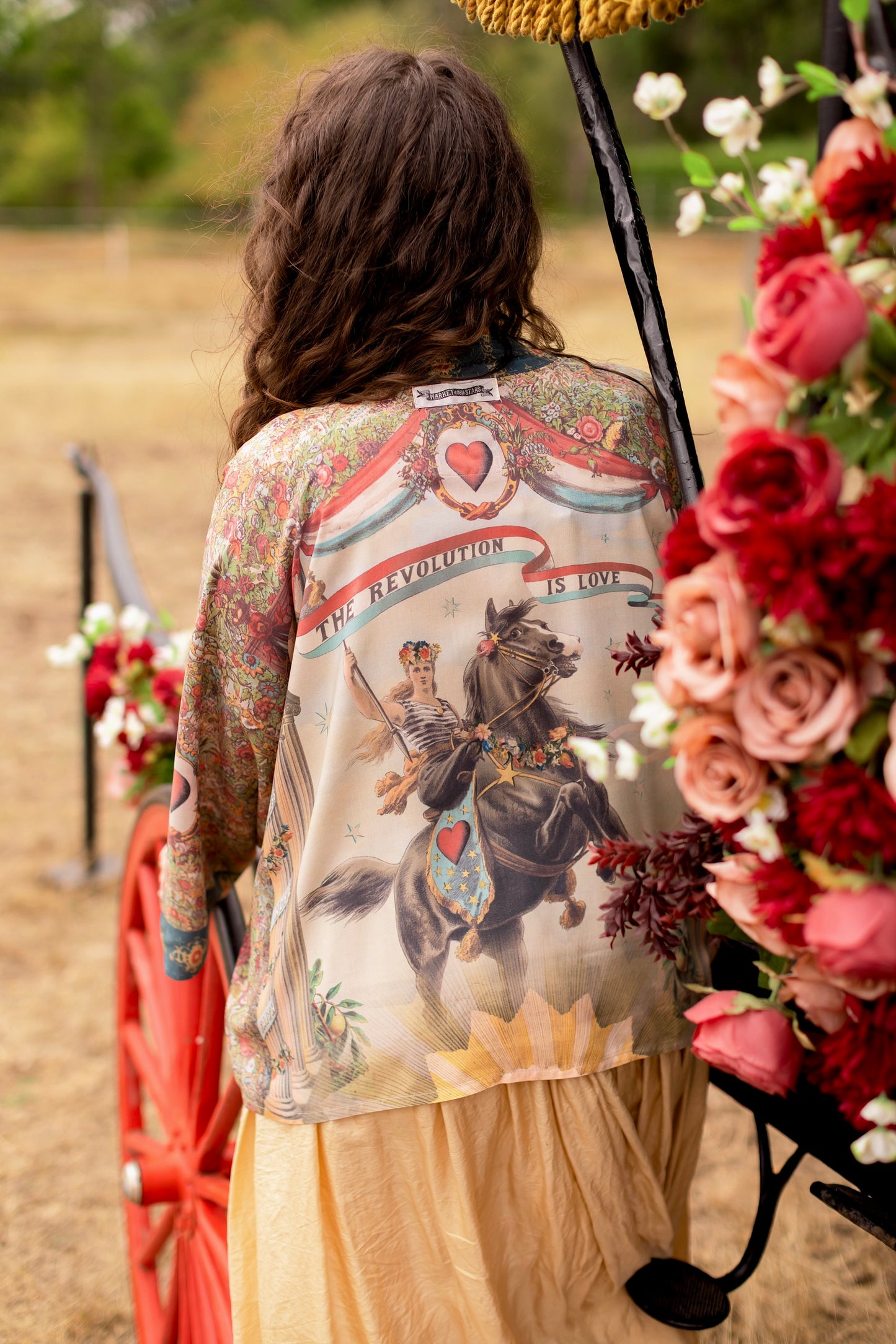 Model wearing cropped length duster ft. a woman astride a rearing horse, soft vintage florals, rosettes and lithographs from the 1800's - Market of Stars