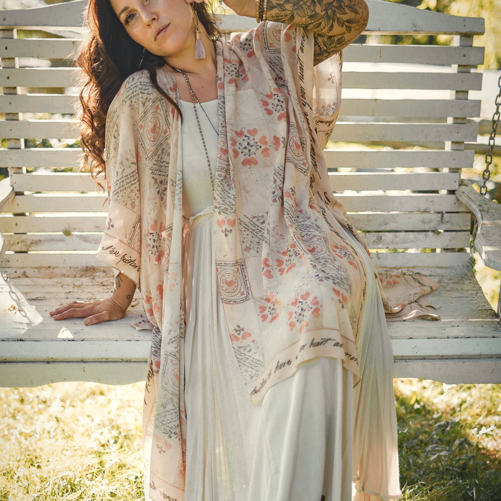 Model wearing romantic kimono with patchwork pattern made from a 200-year-old puzzle purse love letter featuring handwritten poetry and vintage florals – Market of Stars