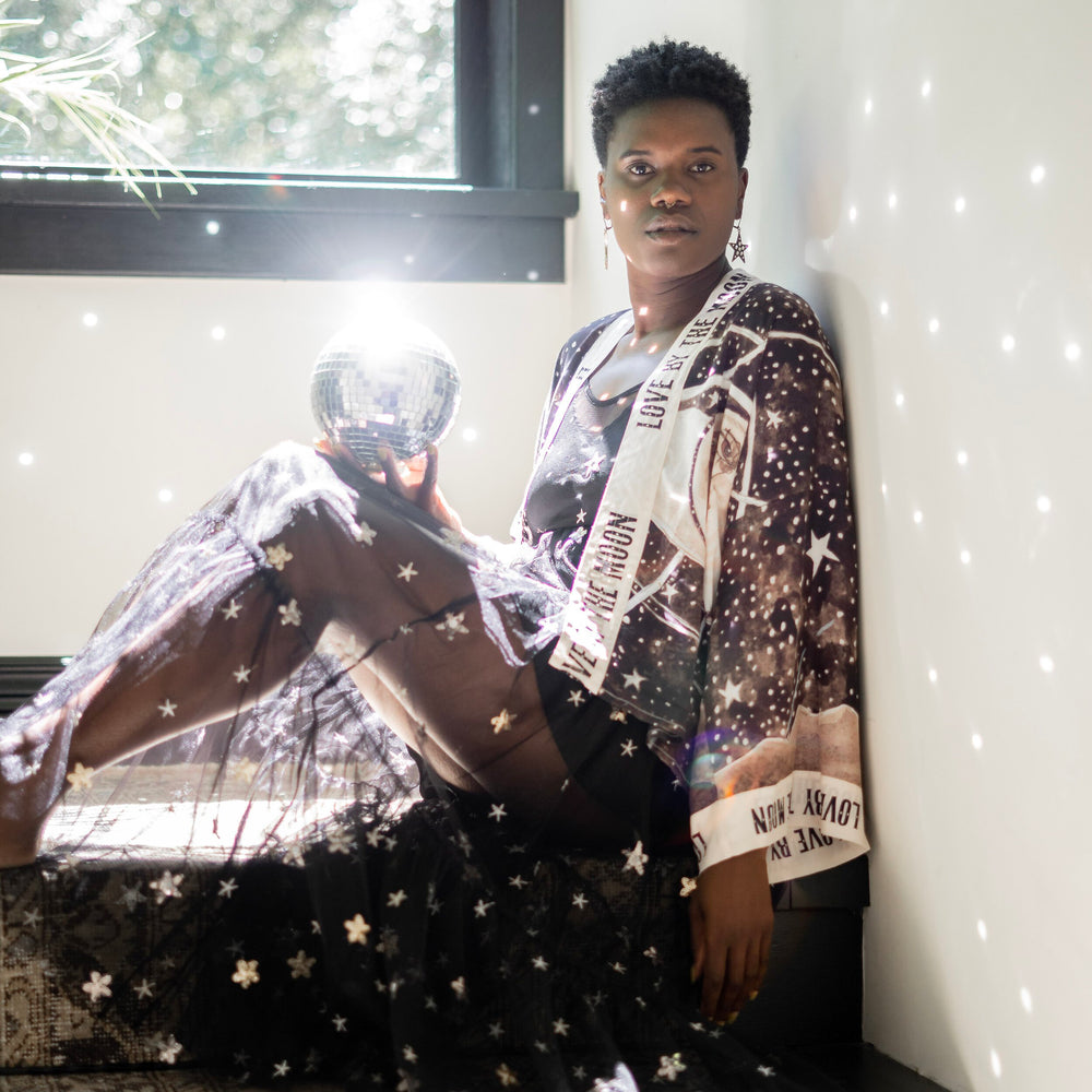 Model wearing Love By The Moon Kimono featuring sepia tones, vintage moon illustration, and retro typography inspired by early 1900s photo props – Market of Stars