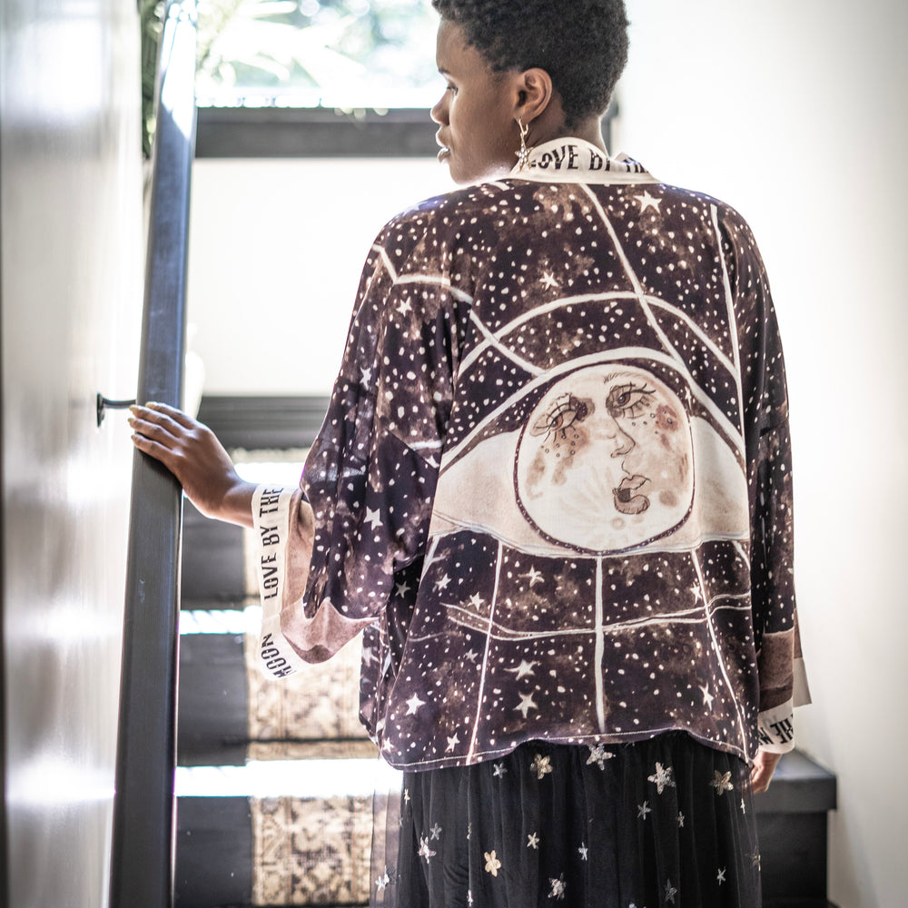 Model wearing Love By The Moon Kimono featuring sepia tones, vintage moon illustration, and retro typography inspired by early 1900s photo props – Market of Stars