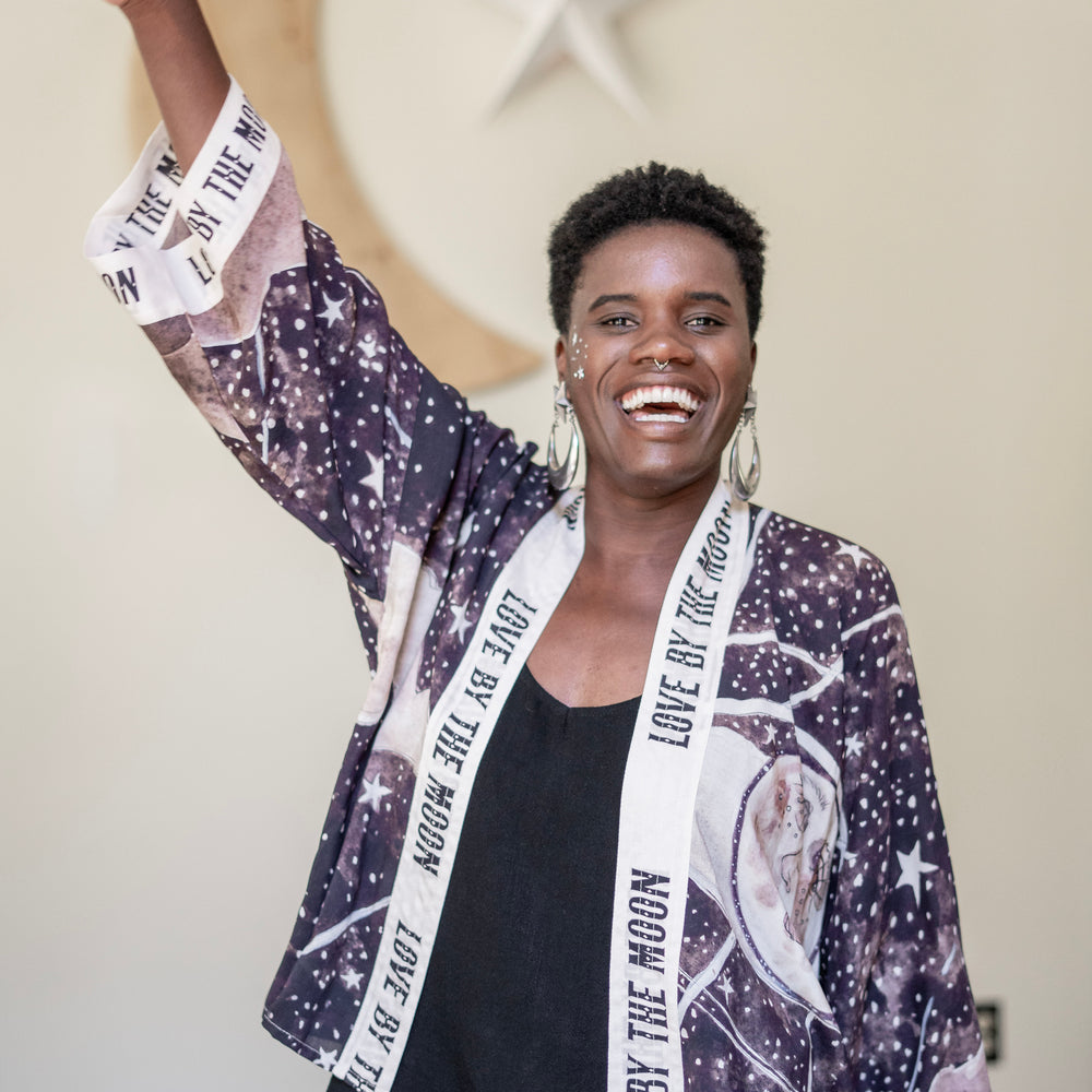 
                  
                    Model wearing Love By The Moon Kimono featuring sepia tones, vintage moon illustration, and retro typography inspired by early 1900s photo props – Market of Stars
                  
                
