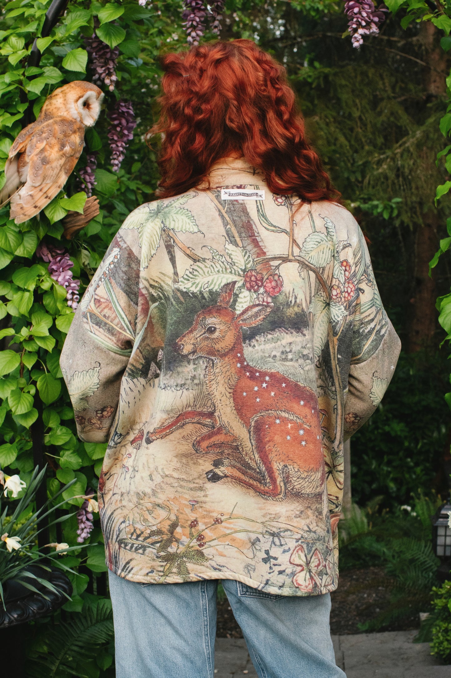 Model wearing the Lovelight Cottage Cardigan ft artwork by world-renowned illustrator Charles van Sandwyk - Market of Stars