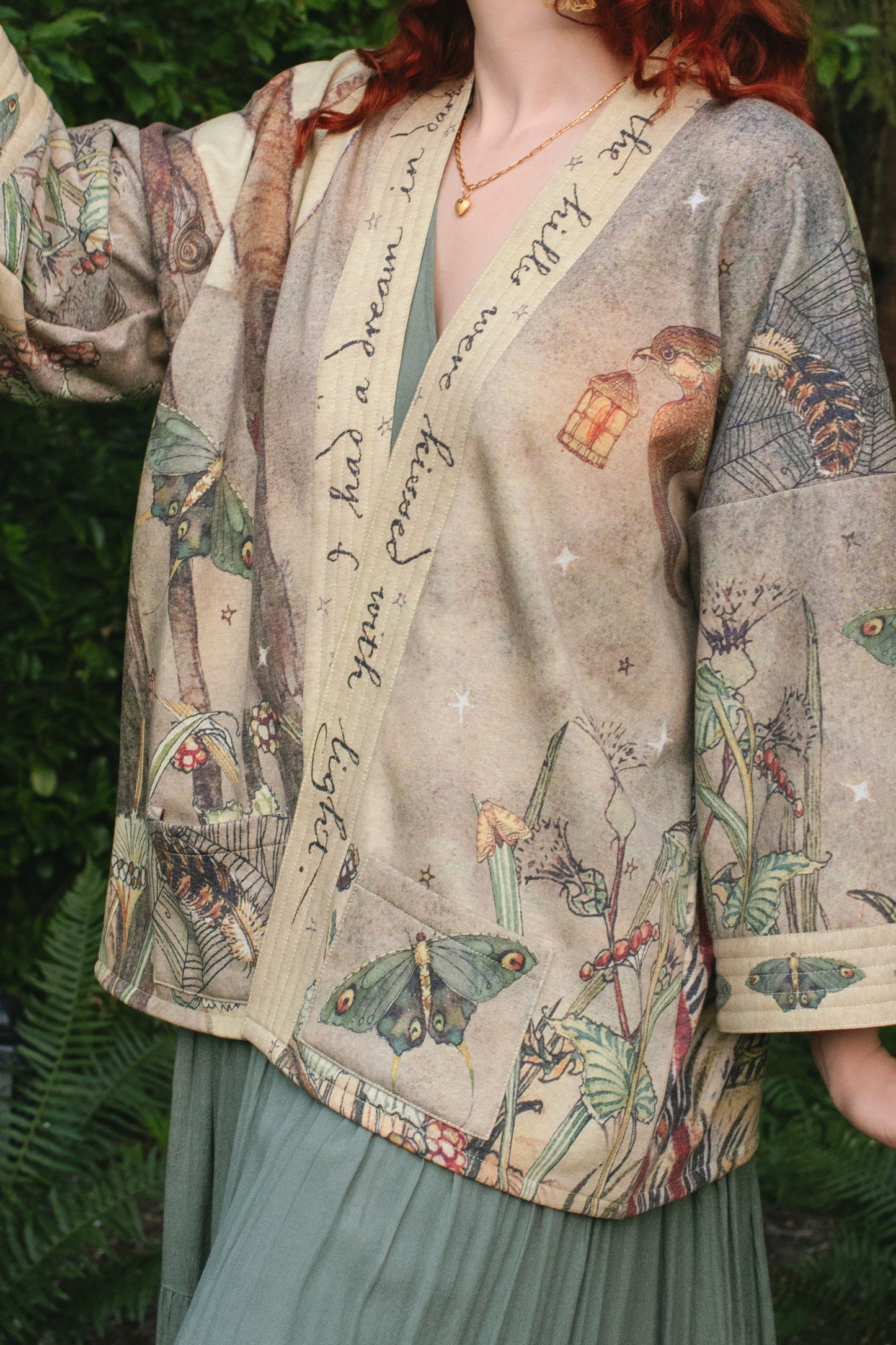 Model wearing the Lovelight Cottage Cardigan ft artwork by world-renowned illustrator Charles van Sandwyk - Market of Stars