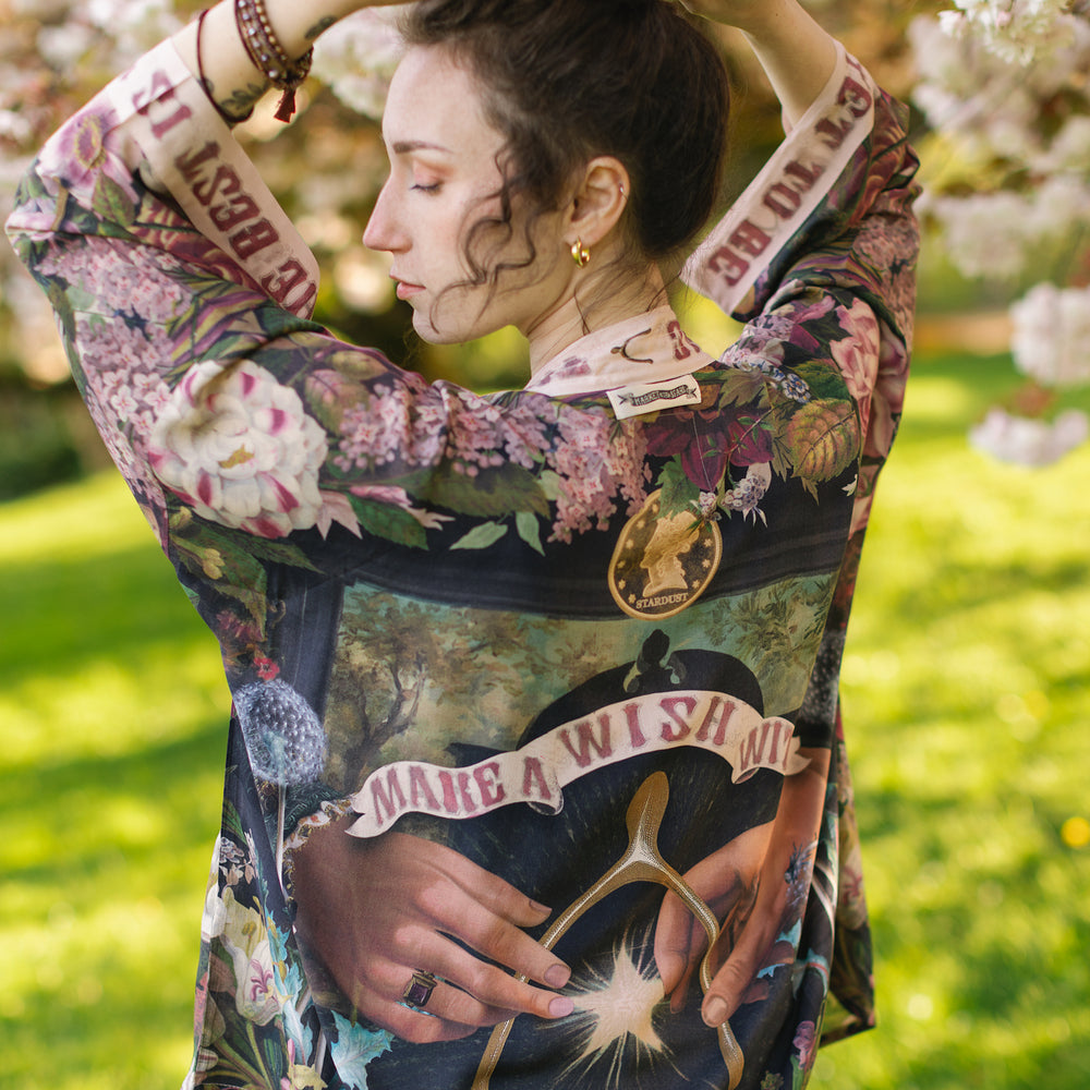Model wearing cropped kimono featuring gold wishbone–vintage coin–evening star–dandelion–and spring floral collage with “Make a wish” banner – Market of Stars
