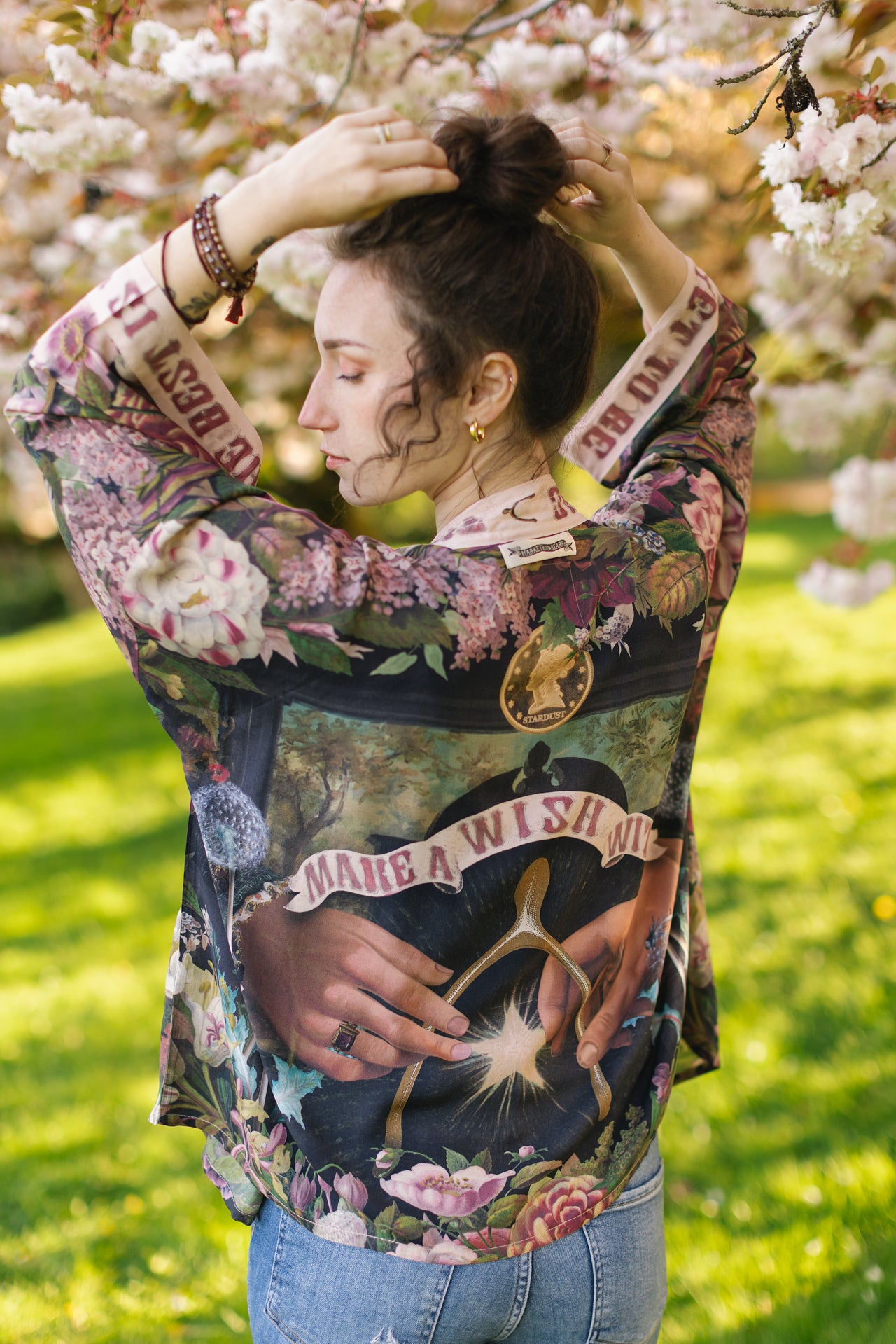 Model wearing cropped kimono featuring gold wishbone–vintage coin–evening star–dandelion–and spring floral collage with “Make a wish” banner – Market of Stars