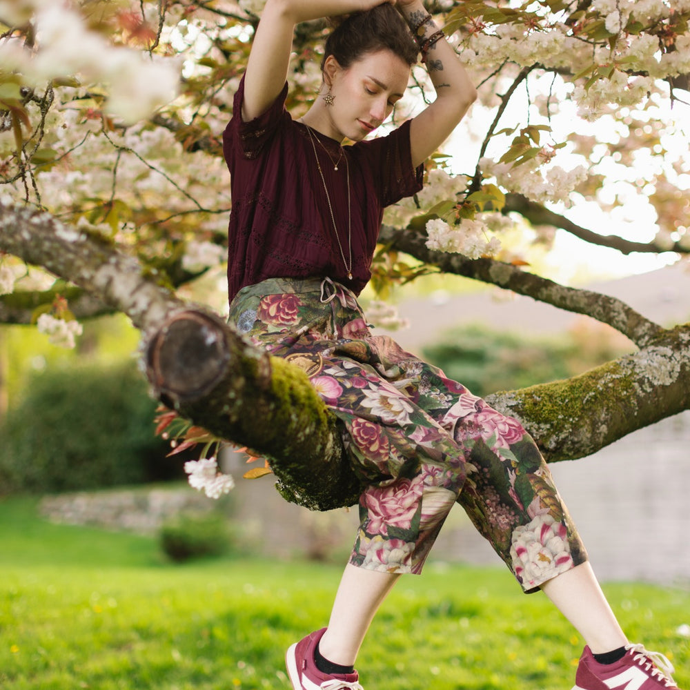 
                  
                    Model wearing linen blend artist pants featuring antique wishbone–Victorian coin–evening star–dandelion art and “Wish with Me” banner on floral background – Market of Stars
                  
                