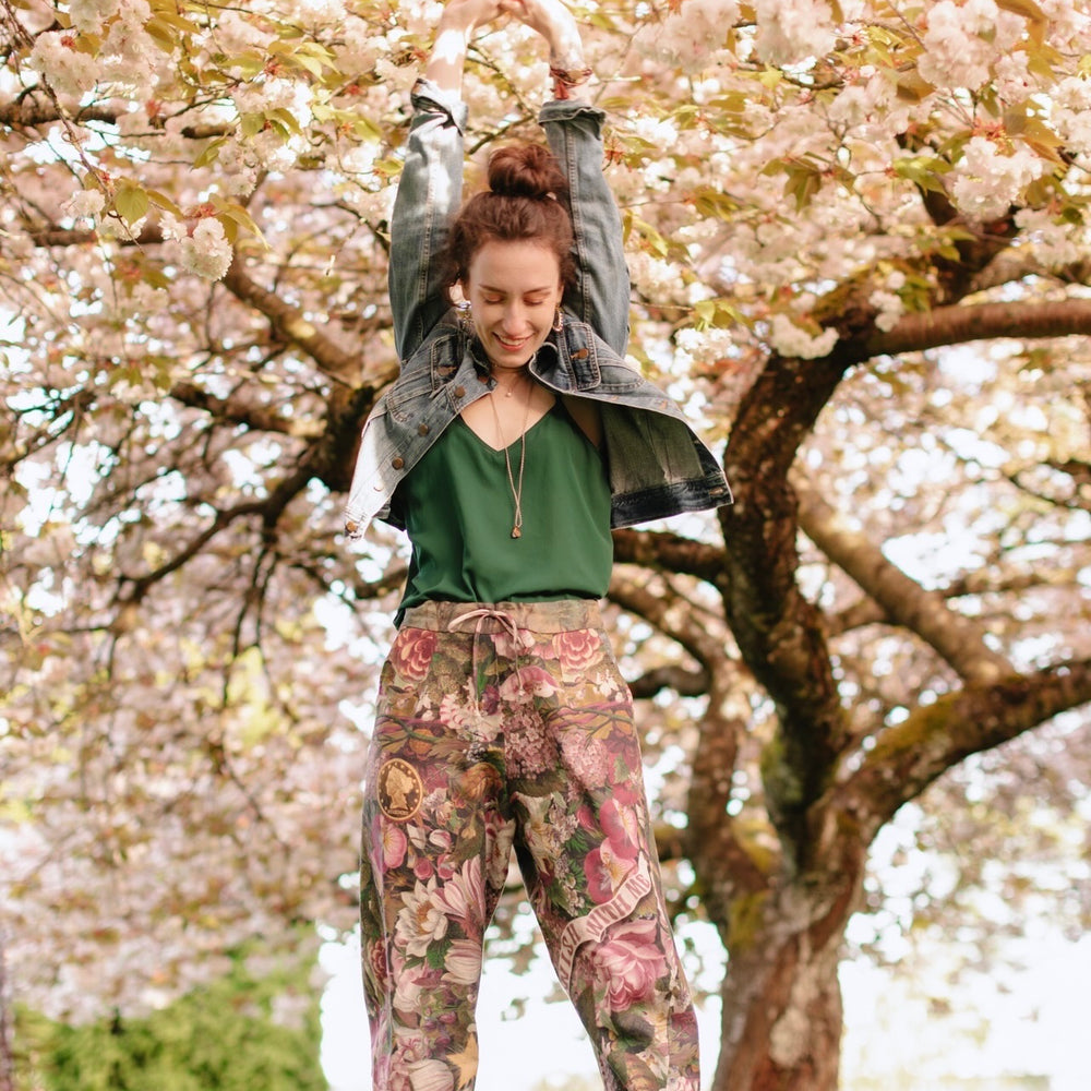 
                  
                    Model wearing linen blend artist pants featuring antique wishbone–Victorian coin–evening star–dandelion art and “Wish with Me” banner on floral background – Market of Stars
                  
                