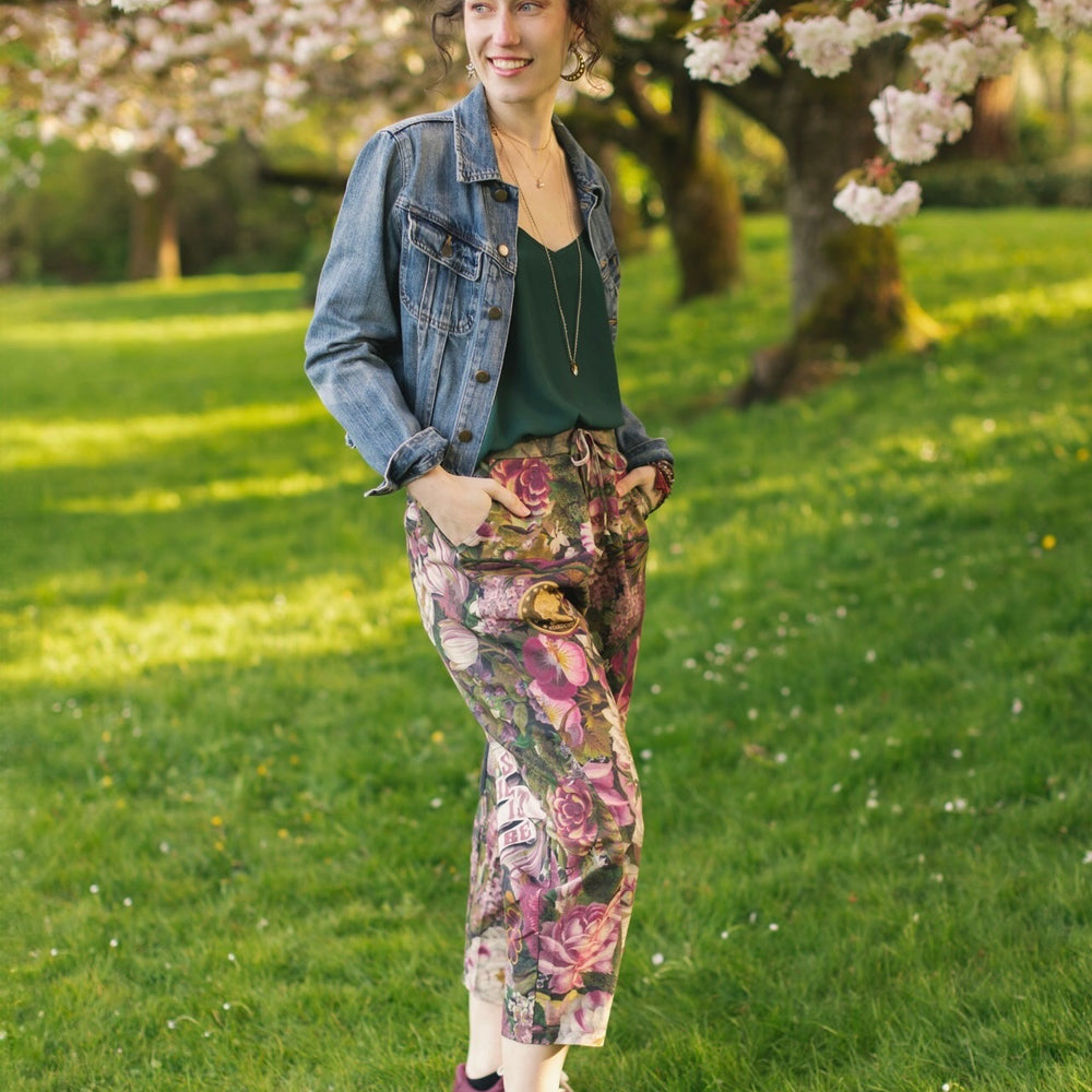 
                  
                    Model wearing linen blend artist pants featuring antique wishbone–Victorian coin–evening star–dandelion art and “Wish with Me” banner on floral background – Market of Stars
                  
                