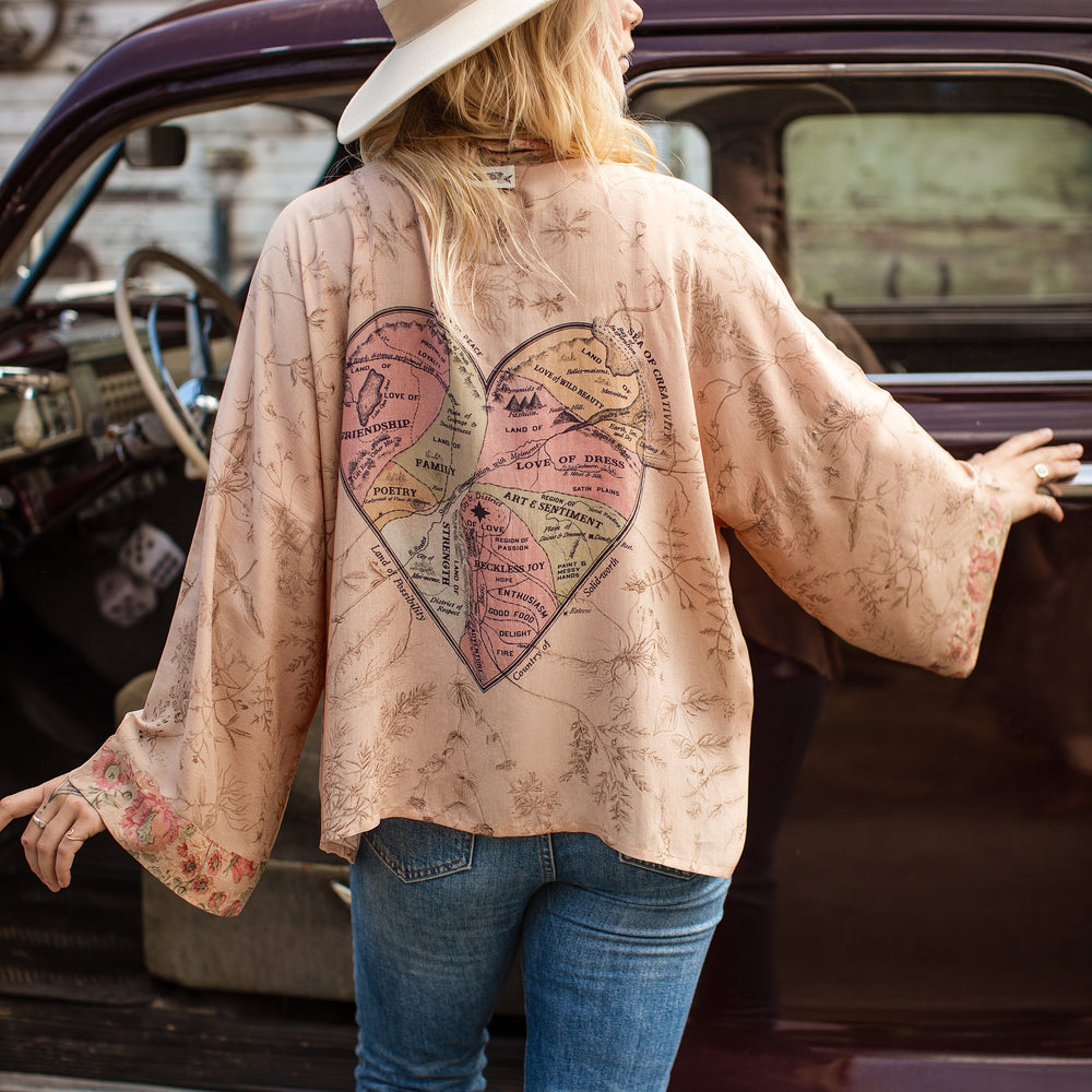 
                  
                    Model wearing map print kimono featuring a reimagined 1846 artwork titled A Map of the Open Country of a Woman’s Heart – Market of Stars
                  
                