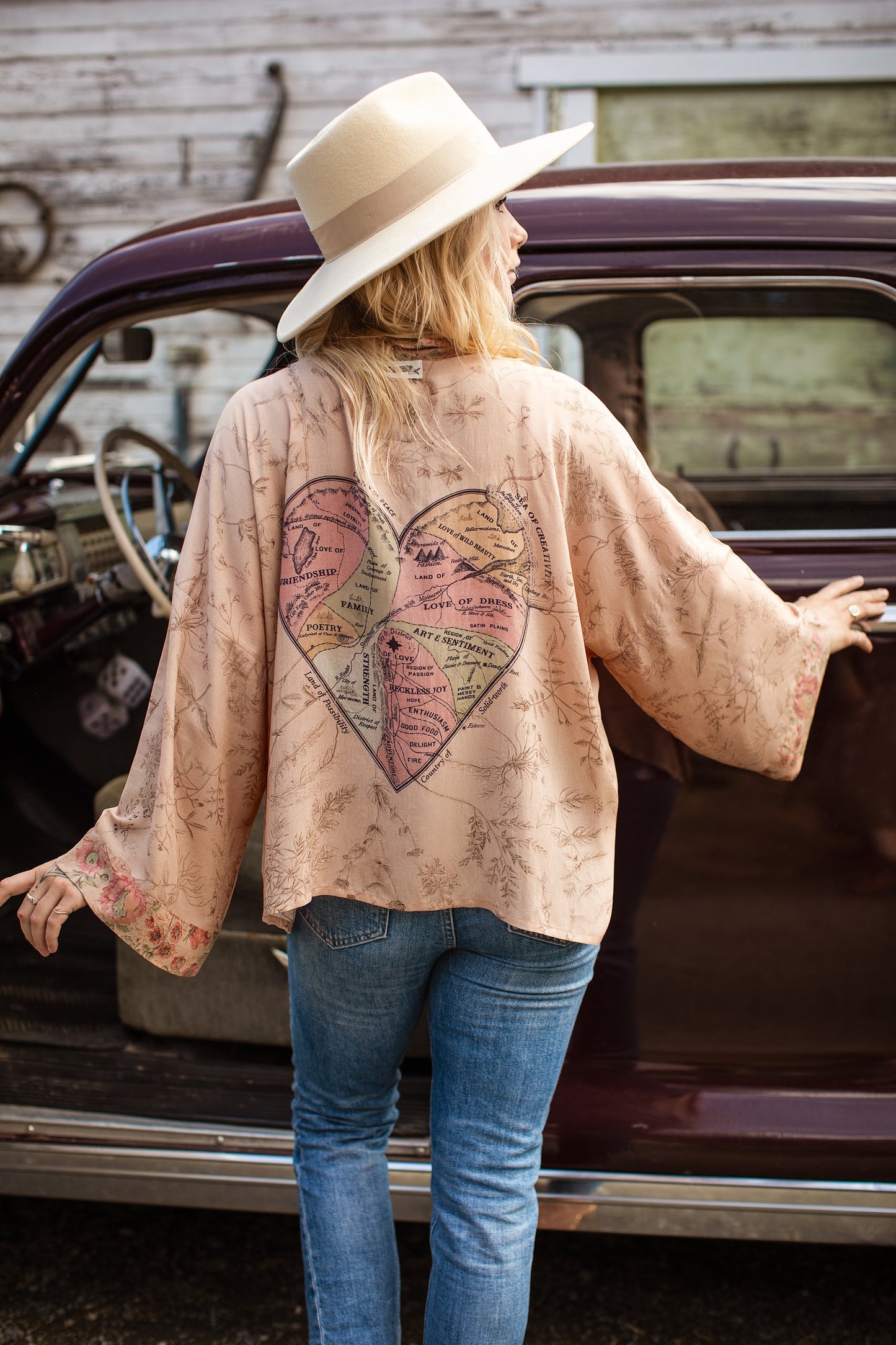 Model wearing map print kimono featuring a reimagined 1846 artwork titled A Map of the Open Country of a Woman’s Heart – Market of Stars