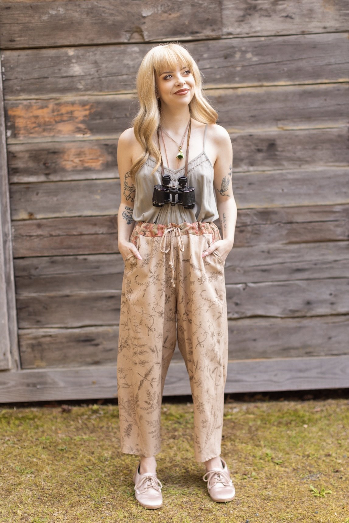 Model wearing artist pants in oat featuring reimagined vintage 1846 map of a woman’s heart with playful updated place names – Market of Stars