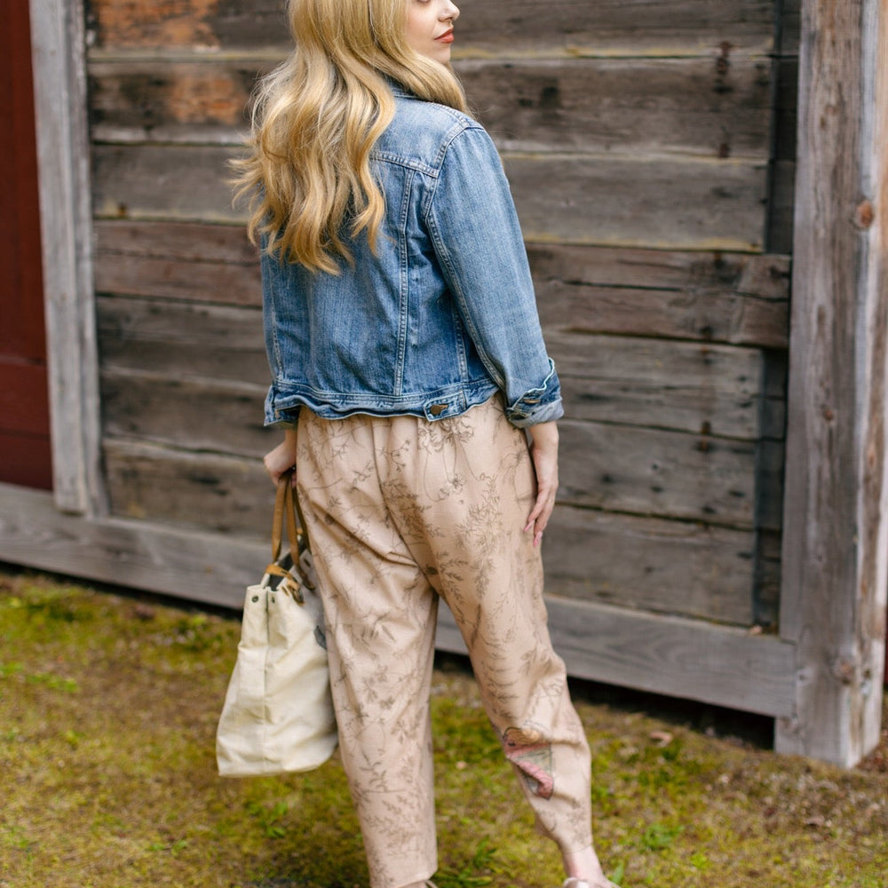 
                  
                    Model wearing artist pants in oat featuring reimagined vintage 1846 map of a woman’s heart with playful updated place names – Market of Stars
                  
                