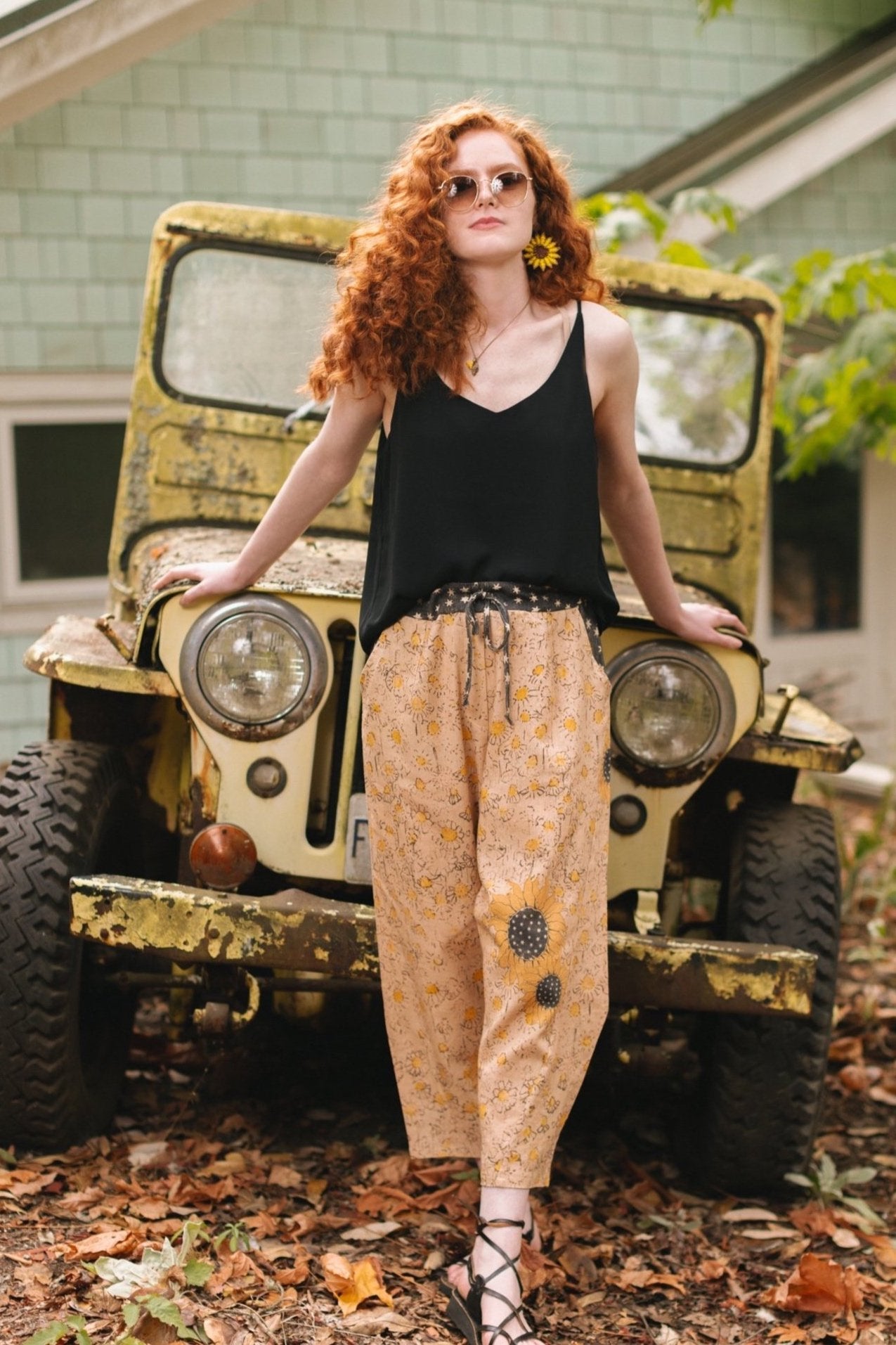Model wearing the Milk & Honey Artist Pants featuring playful 1904 Brooklyn poster art and antique woodcut star and floral details in vintage-inspired tones – Market of Stars.