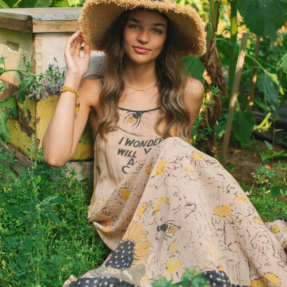 
                  
                    Model wearing the Milk & Honey Bohéme Slip Dress featuring nostalgic 1904 Brooklyn artwork, vintage woodcut stars, and Hoytema’s antique floral print – Market of Stars.
                  
                