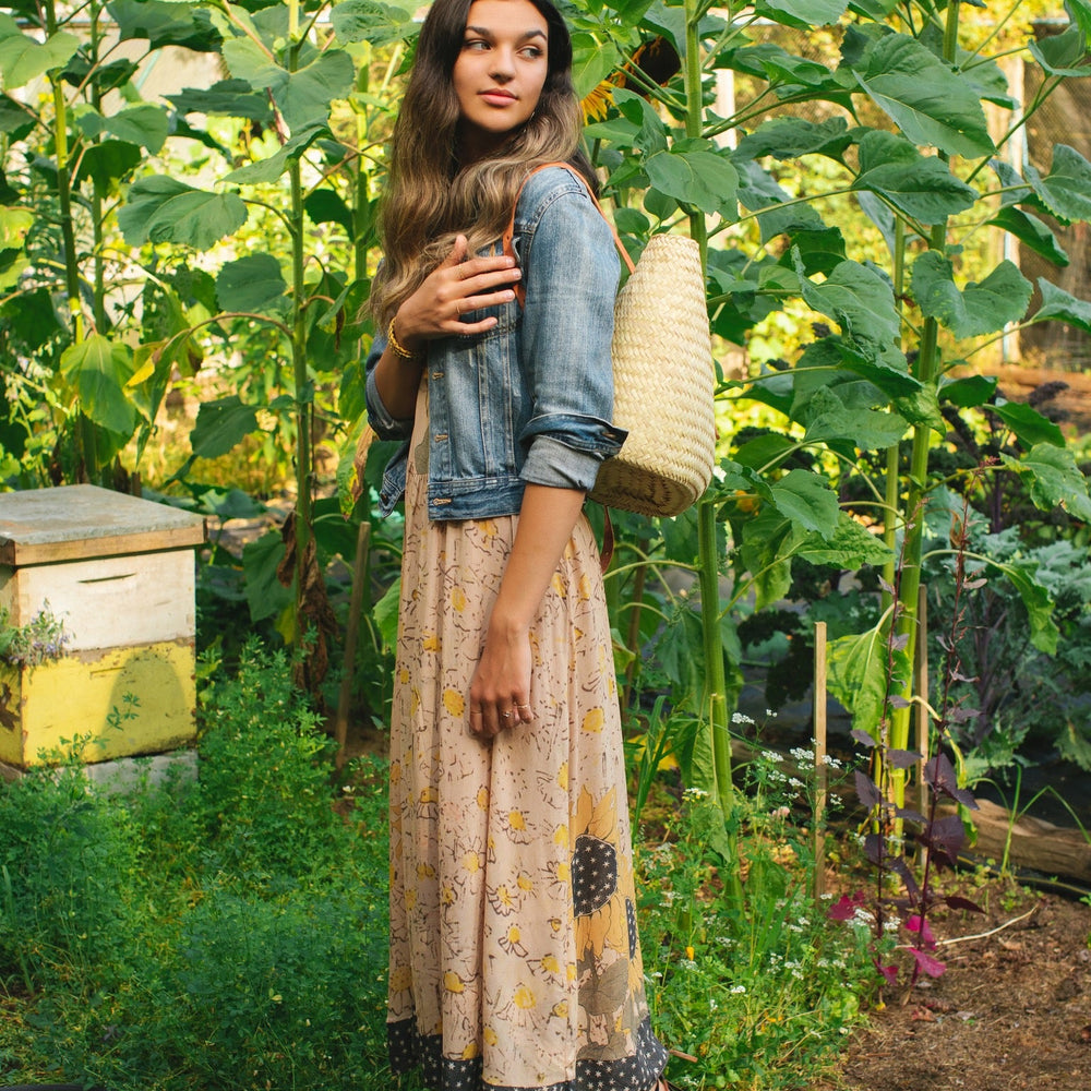 
                  
                    Model wearing the Milk & Honey Bohéme Slip Dress featuring nostalgic 1904 Brooklyn artwork, vintage woodcut stars, and Hoytema’s antique floral print – Market of Stars.
                  
                