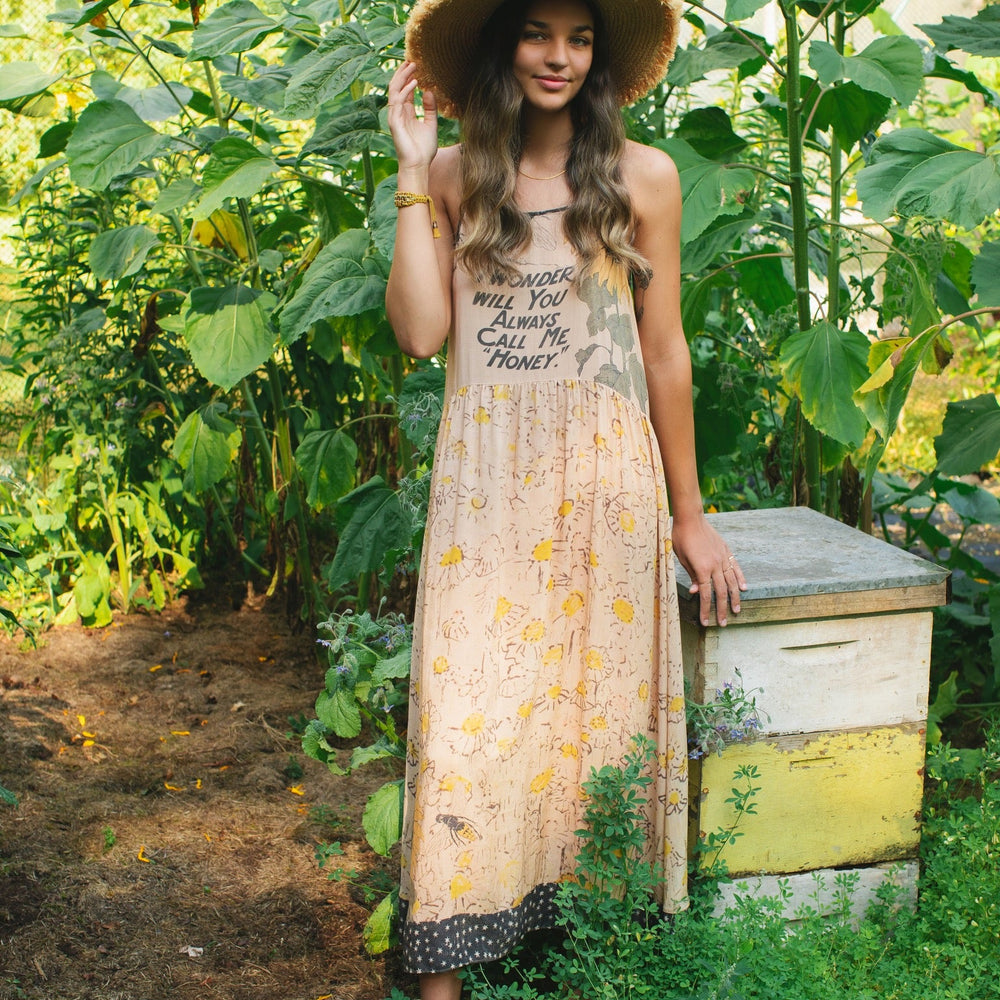 
                  
                    Model wearing the Milk & Honey Bohéme Slip Dress featuring nostalgic 1904 Brooklyn artwork, vintage woodcut stars, and Hoytema’s antique floral print – Market of Stars.
                  
                