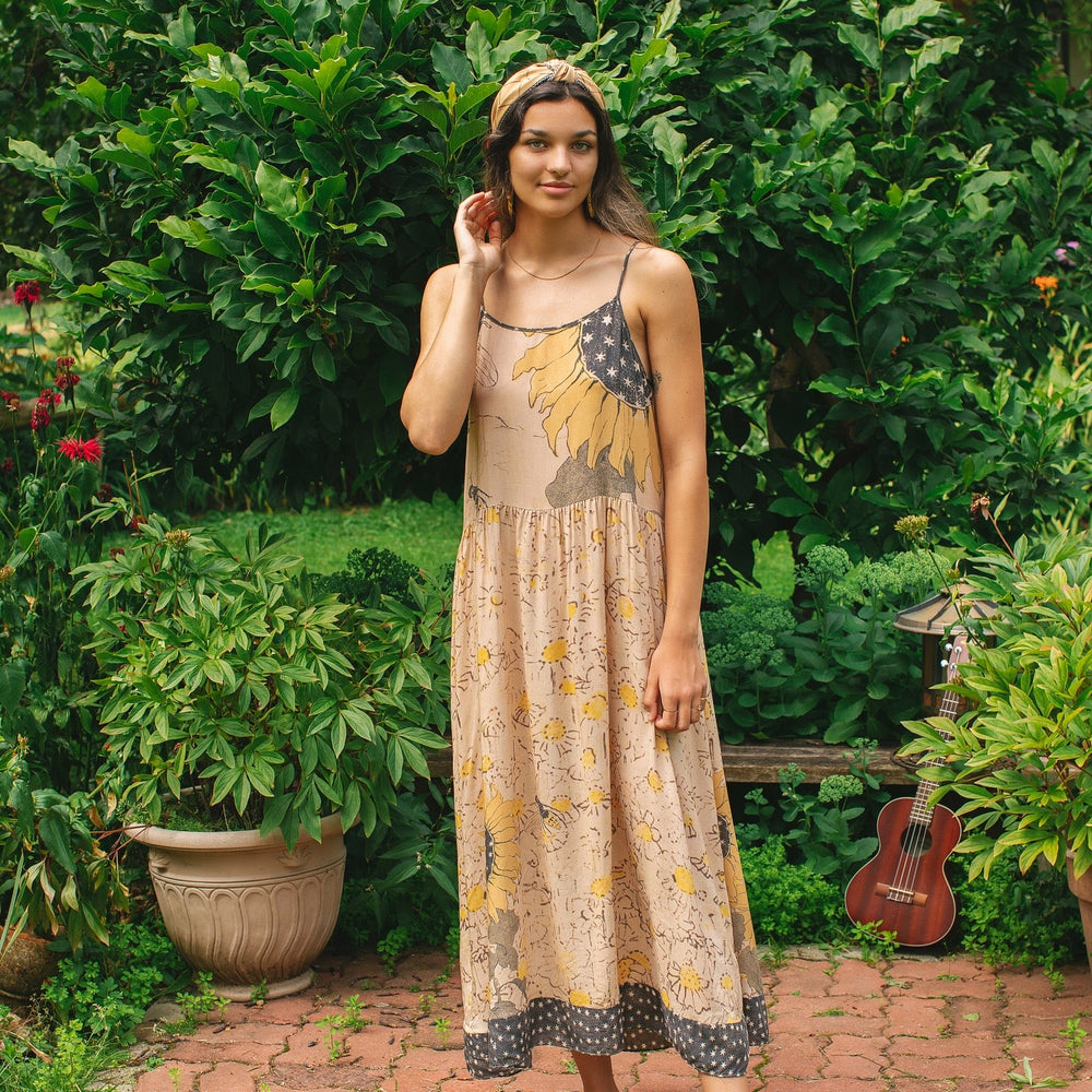 
                  
                    Model wearing the Milk & Honey Bohéme Slip Dress featuring nostalgic 1904 Brooklyn artwork, vintage woodcut stars, and Hoytema’s antique floral print – Market of Stars.
                  
                