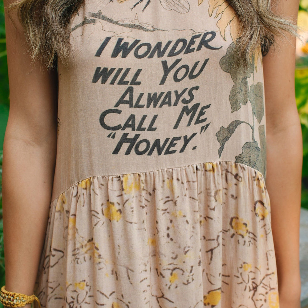 
                  
                    Model wearing the Milk & Honey Bohéme Slip Dress featuring nostalgic 1904 Brooklyn artwork, vintage woodcut stars, and Hoytema’s antique floral print – Market of Stars.
                  
                
