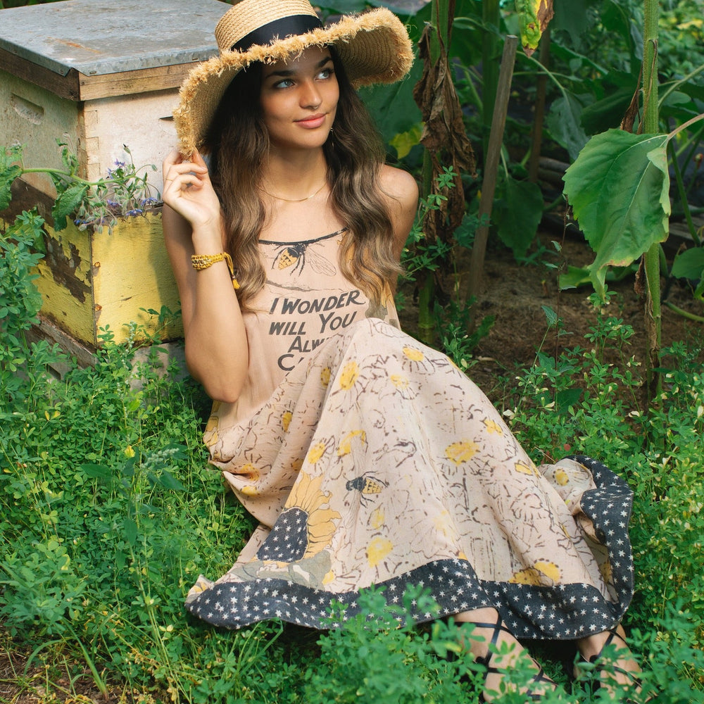 
                  
                    Model wearing the Milk & Honey Bohéme Slip Dress featuring nostalgic 1904 Brooklyn artwork, vintage woodcut stars, and Hoytema’s antique floral print – Market of Stars.
                  
                