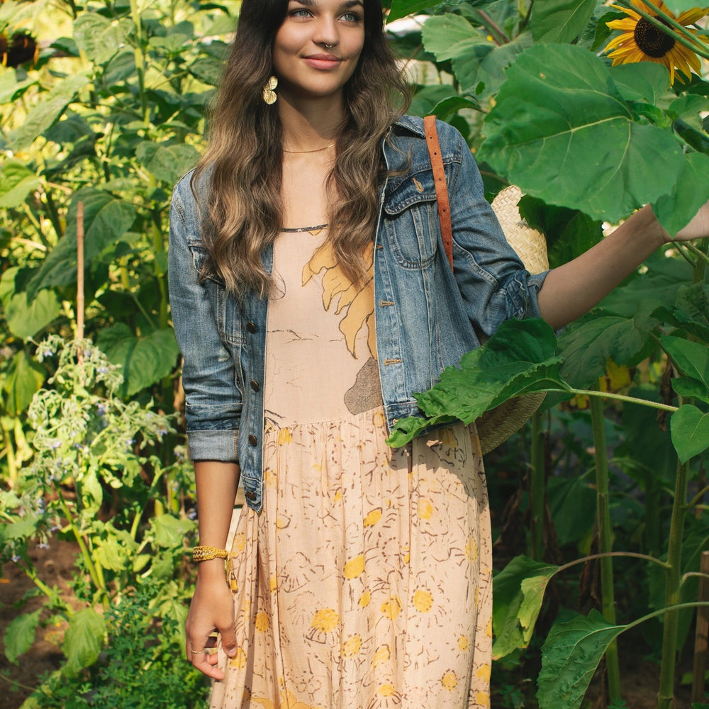 
                  
                    Model wearing the Milk & Honey Bohéme Slip Dress featuring nostalgic 1904 Brooklyn artwork, vintage woodcut stars, and Hoytema’s antique floral print – Market of Stars.
                  
                