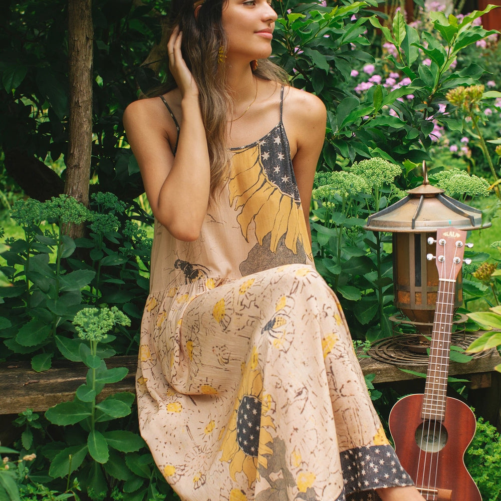 
                  
                    Model wearing the Milk & Honey Bohéme Slip Dress featuring nostalgic 1904 Brooklyn artwork, vintage woodcut stars, and Hoytema’s antique floral print – Market of Stars.
                  
                