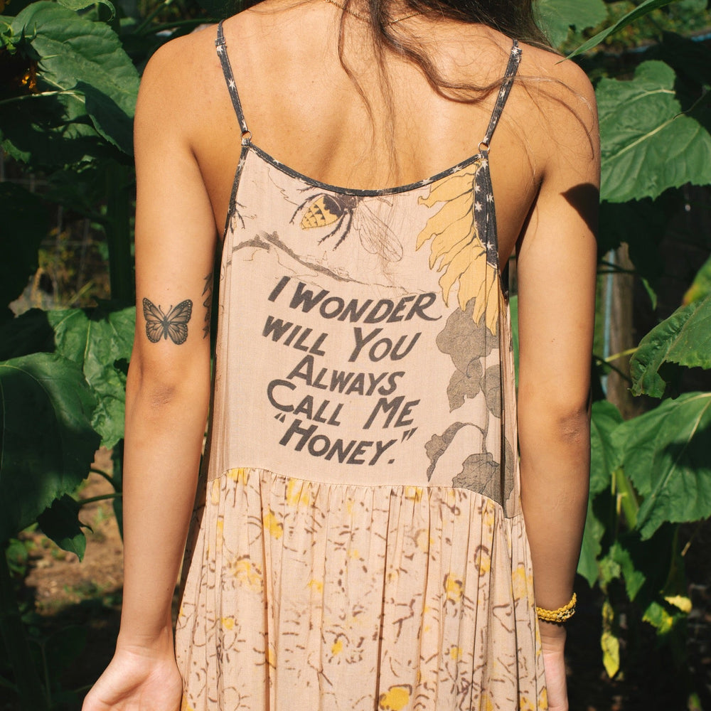 
                  
                    Model wearing the Milk & Honey Bohéme Slip Dress featuring nostalgic 1904 Brooklyn artwork, vintage woodcut stars, and Hoytema’s antique floral print – Market of Stars.
                  
                
