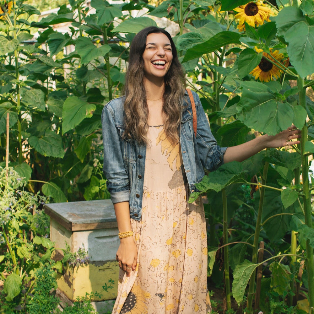 
                  
                    Model wearing the Milk & Honey Bohéme Slip Dress featuring nostalgic 1904 Brooklyn artwork, vintage woodcut stars, and Hoytema’s antique floral print – Market of Stars.
                  
                