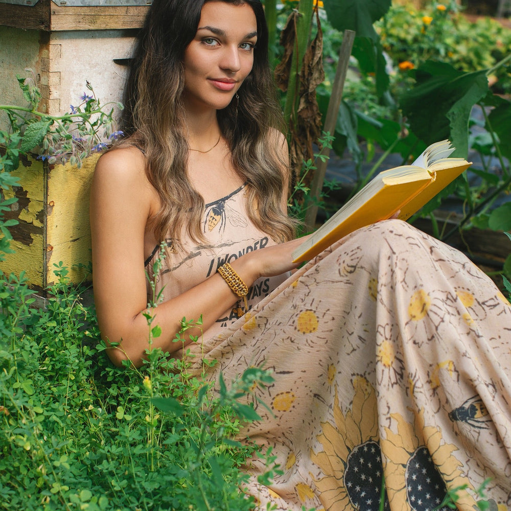 
                  
                    Model wearing the Milk & Honey Bohéme Slip Dress featuring nostalgic 1904 Brooklyn artwork, vintage woodcut stars, and Hoytema’s antique floral print – Market of Stars.
                  
                