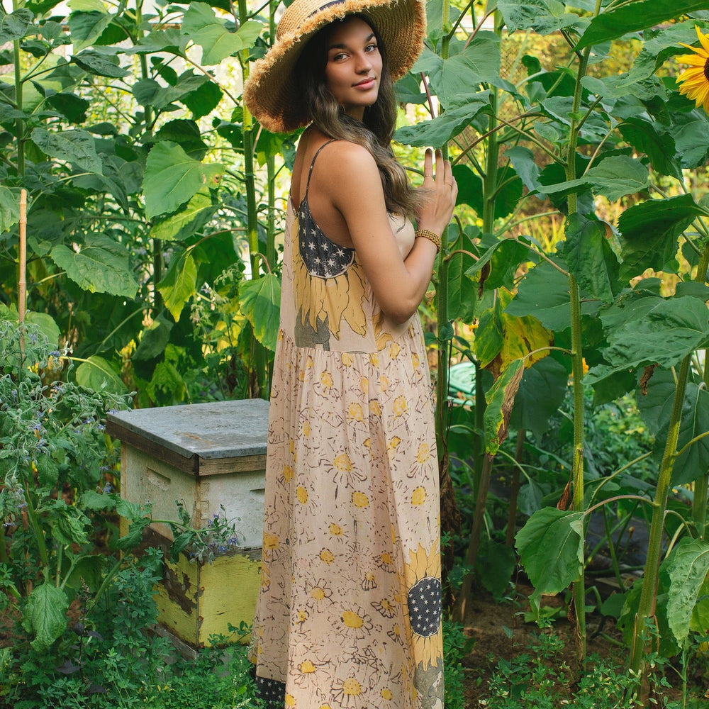 
                  
                    Model wearing the Milk & Honey Bohéme Slip Dress featuring nostalgic 1904 Brooklyn artwork, vintage woodcut stars, and Hoytema’s antique floral print – Market of Stars.
                  
                