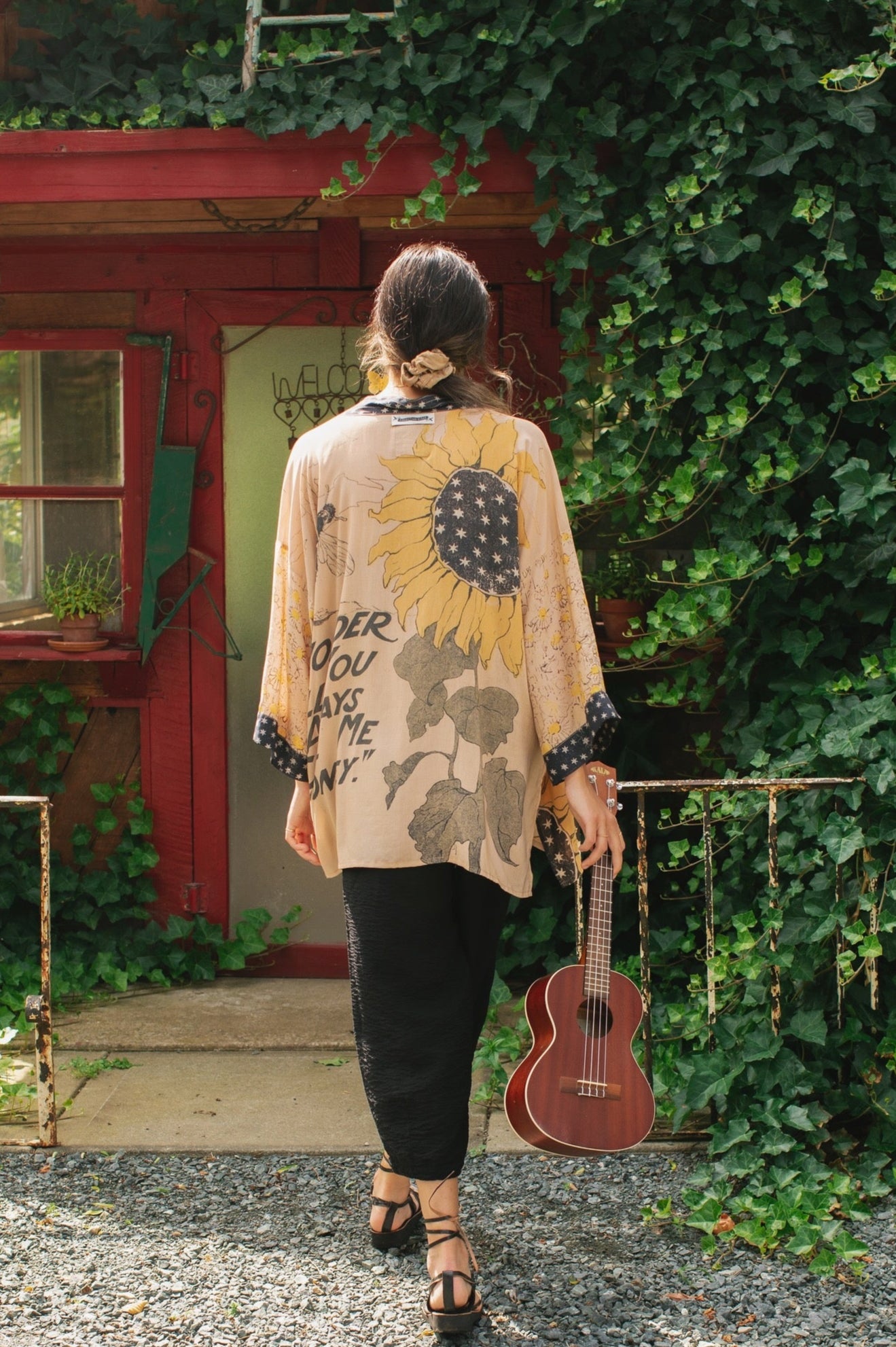 Model wearing our matinee length kimono featuring vintage-inspired Milk & Honey print with 1904 typography and floral woodcuts – Market of Stars