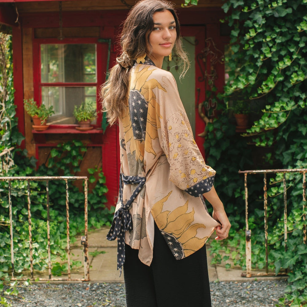 
                  
                    Model wearing our matinee length kimono featuring vintage-inspired Milk & Honey print with 1904 typography and floral woodcuts – Market of Stars
                  
                