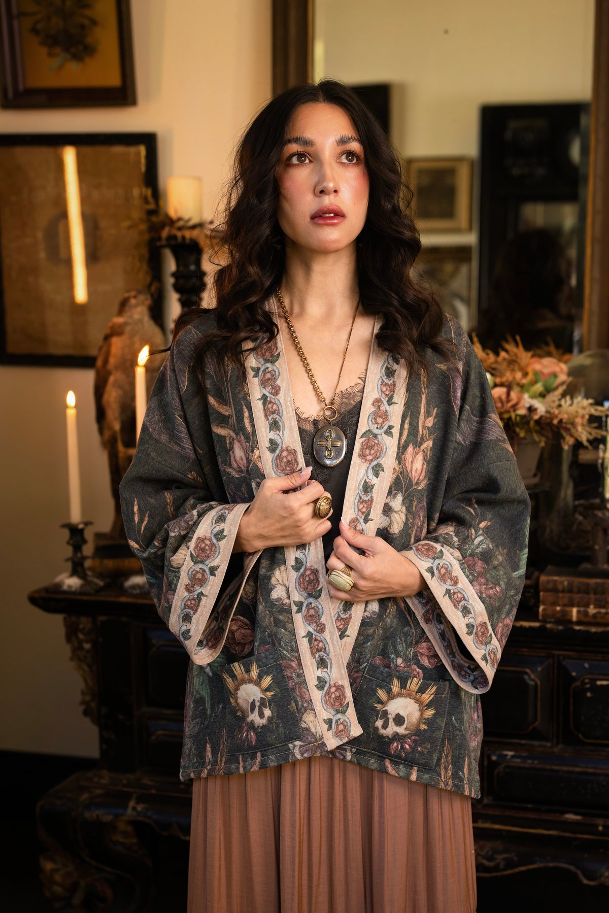 Model wearing a cozy fleece lined cottage cardigan ft. artwork created by Jessica Roux including two starlings beneath a full moon with flowers, butterflies, moths and botanical artwork - Market of Stars
