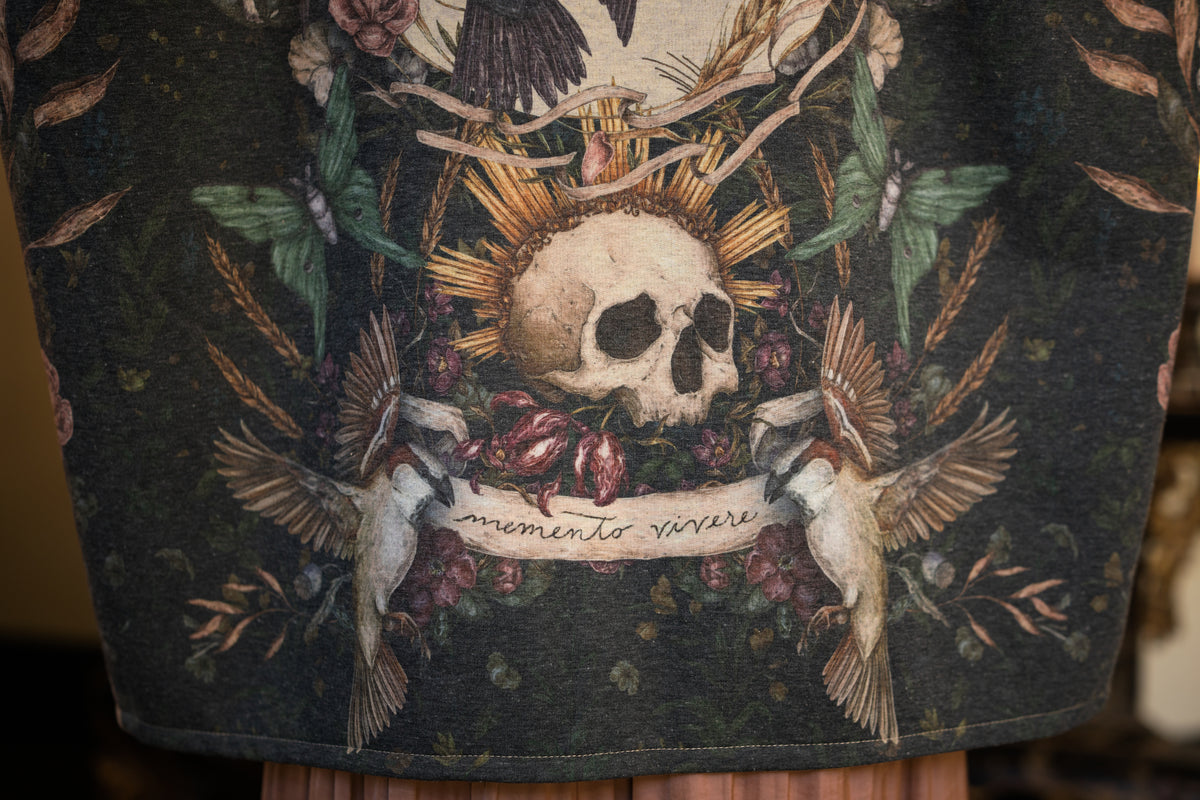 Model wearing a cozy fleece lined cottage cardigan ft. artwork created by Jessica Roux including two starlings beneath a full moon with flowers, butterflies, moths and botanical artwork - Market of Stars