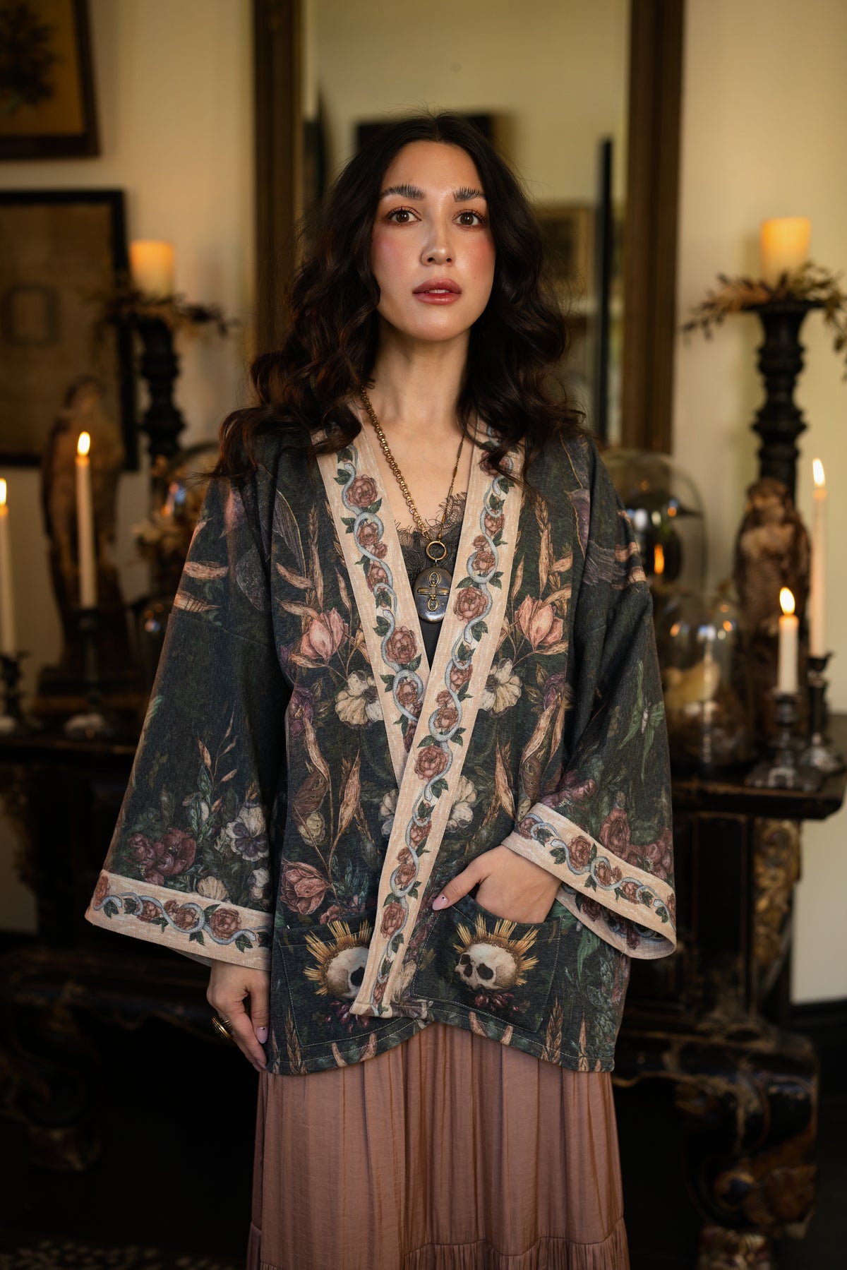 Model wearing a cozy fleece lined cottage cardigan ft. artwork created by Jessica Roux including two starlings beneath a full moon with flowers, butterflies, moths and botanical artwork - Market of Stars