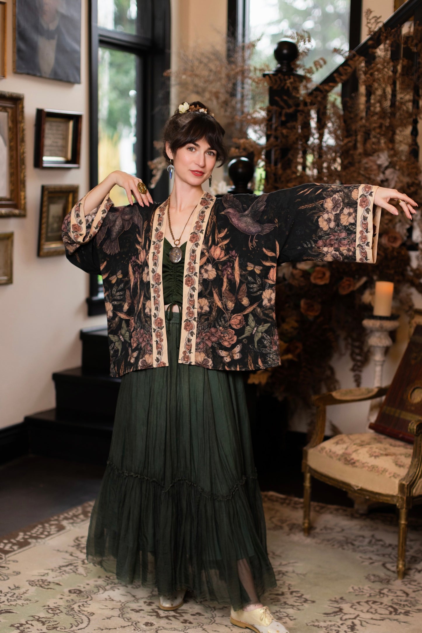 Model wearing a cropped-length duster ft. artwork created by Jessica Roux including two starlings beneath a full moon with flowers, butterflies, moths and botanical artwork - Market of Stars