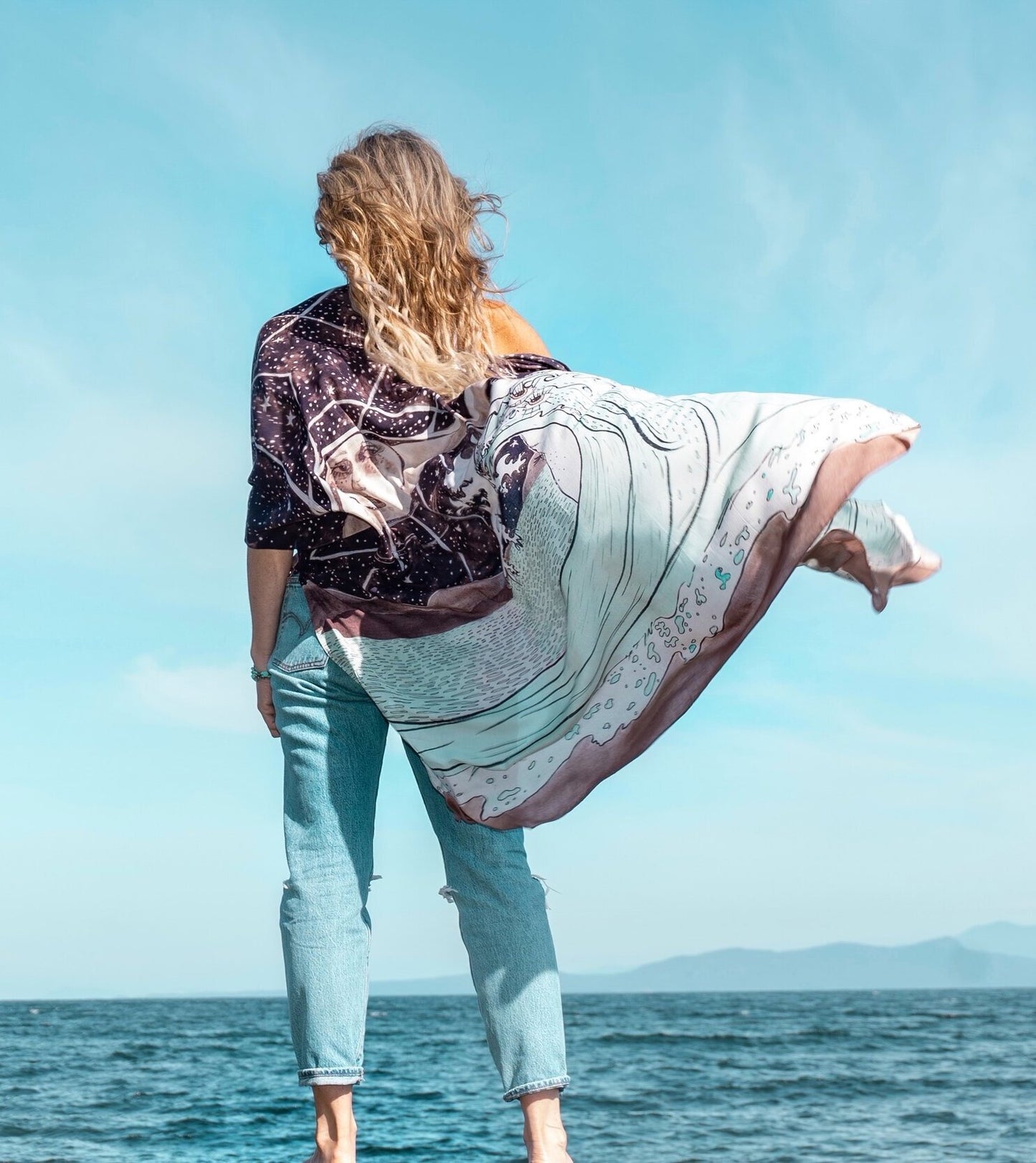 Model wearing Moonstruck Goddess Duster featuring original artwork by Leslie Love, inspired by the ocean, the night sky, and the artist’s handmade botanical inks – Market of Stars.