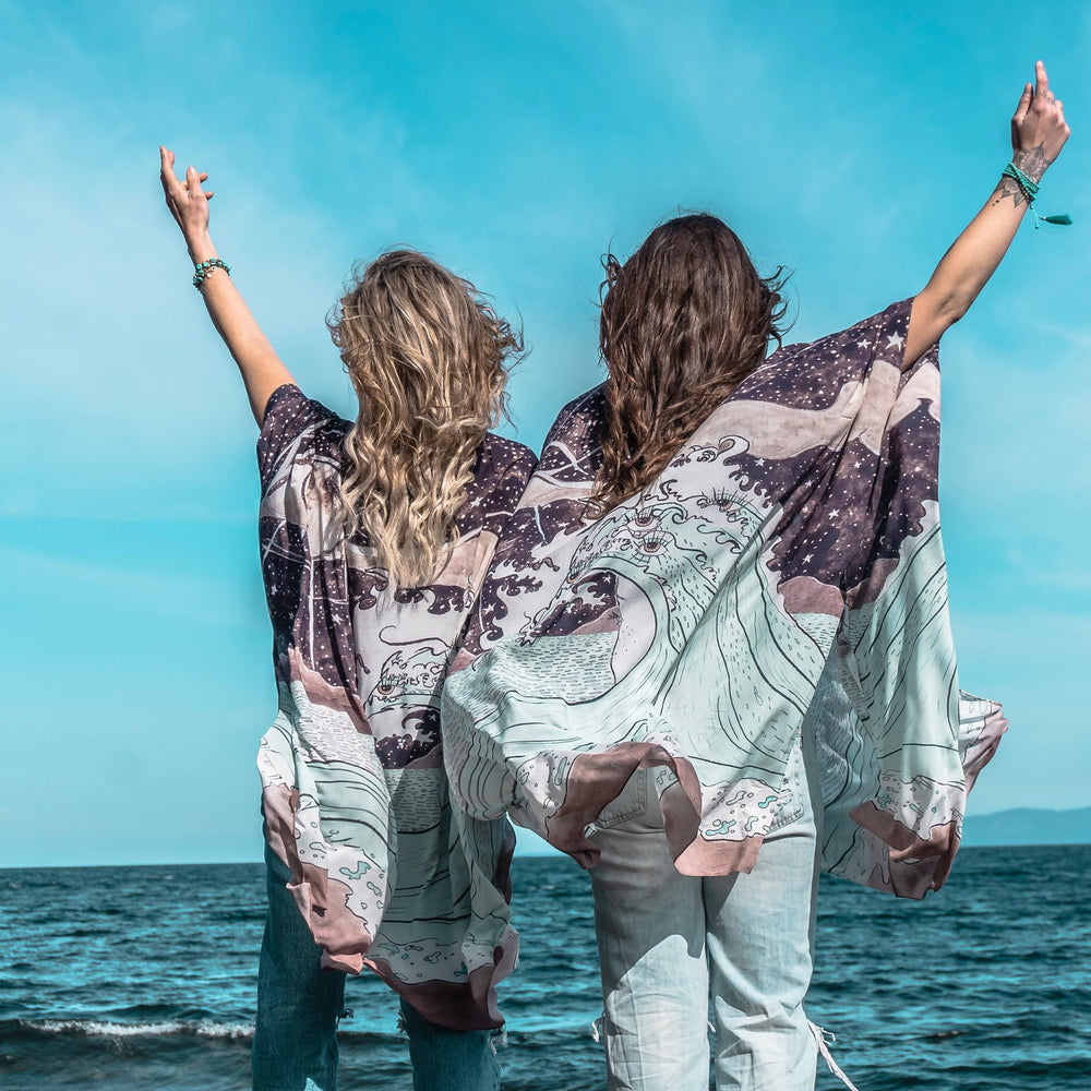 Model wearing Moonstruck Goddess Duster featuring original artwork by Leslie Love, inspired by the ocean, the night sky, and the artist’s handmade botanical inks – Market of Stars.