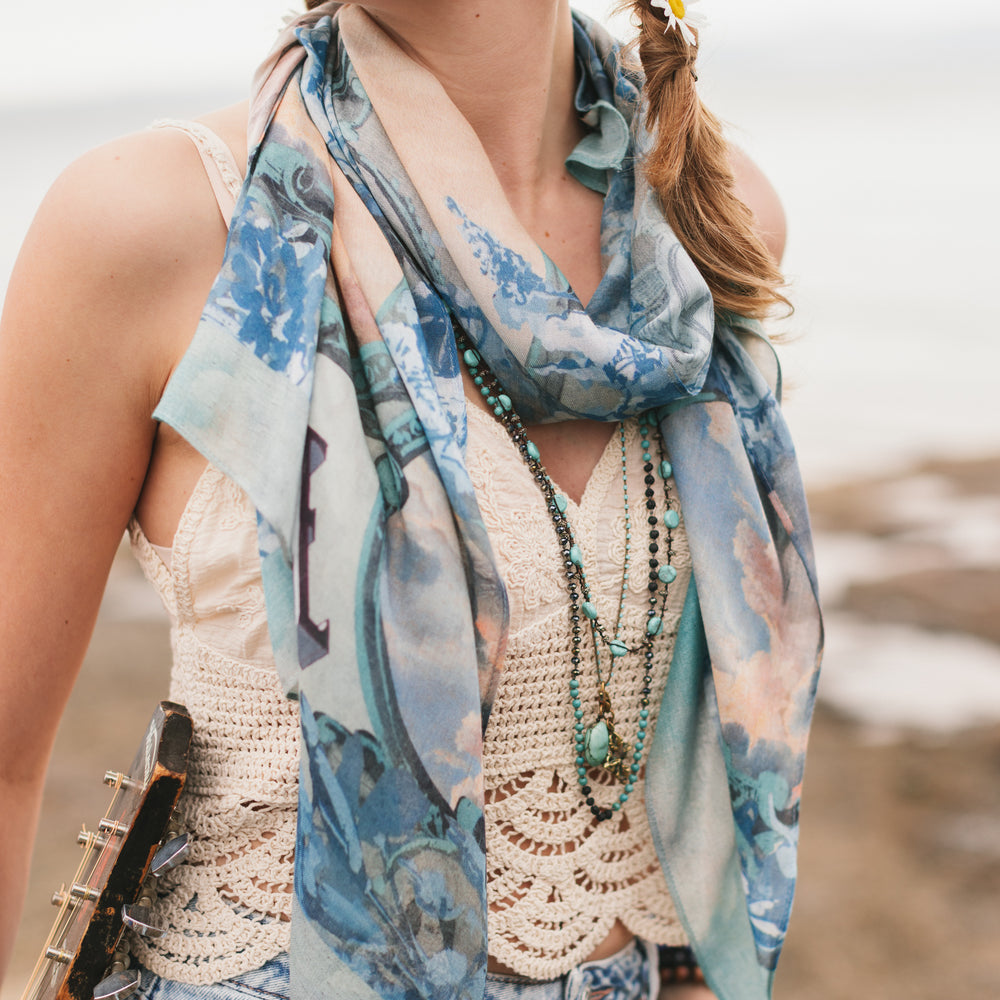 
                  
                    Model wearing a light, airy bamboo-based viscose scarf to wrap yourself in good vibes, wanderlust, and a little rebellion - Market of Stars
                  
                