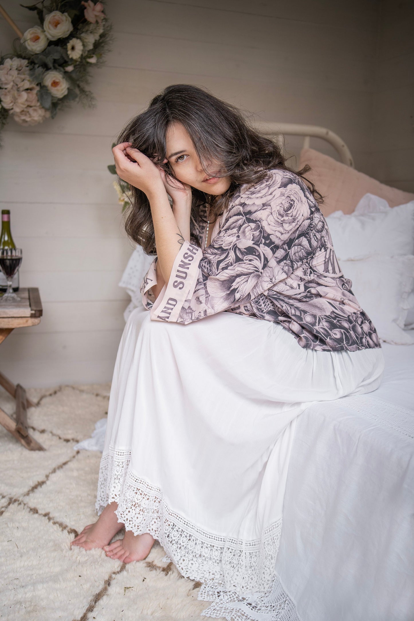 Model wearing Peace, Wine & Sunshine Bohéme Slip Dress featuring botanical collages and playful peace, wine and sunshine lettering on the hem – Market of Stars.