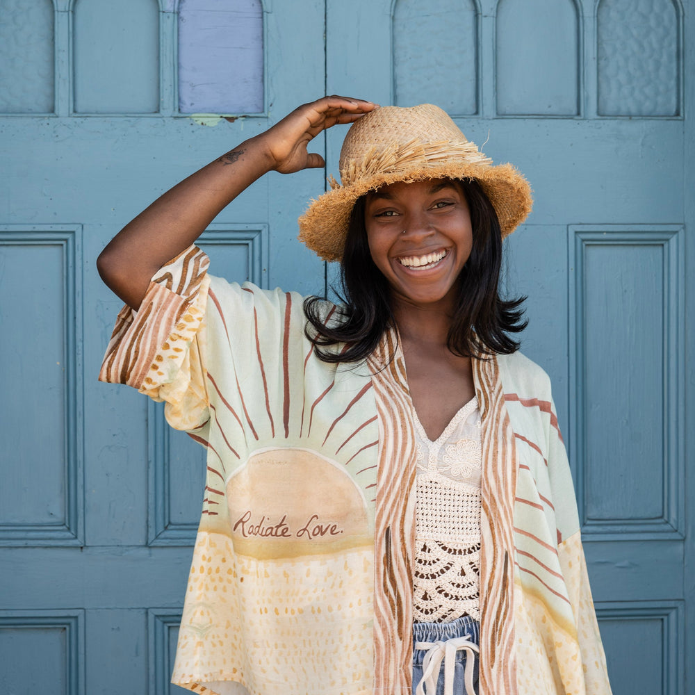 Model wearing Peace, Wine & Sunshine Bohéme Slip Dress featuring botanical collages and playful peace, wine and sunshine lettering on the hem – Market of Stars.