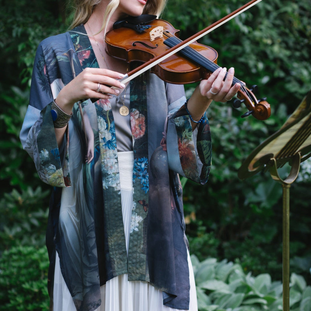 
                  
                    Model wearing Peace, Wine & Sunshine Bohéme Slip Dress featuring botanical collages and playful peace, wine and sunshine lettering on the hem – Market of Stars.
                  
                