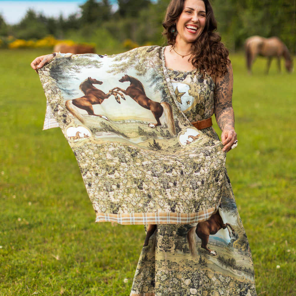 
                  
                    Model wearing a bamboo-viscose scarf made for everyday adventures with a whimsical print celebrating one's unbridled spirit of adventure - Market of Stars
                  
                