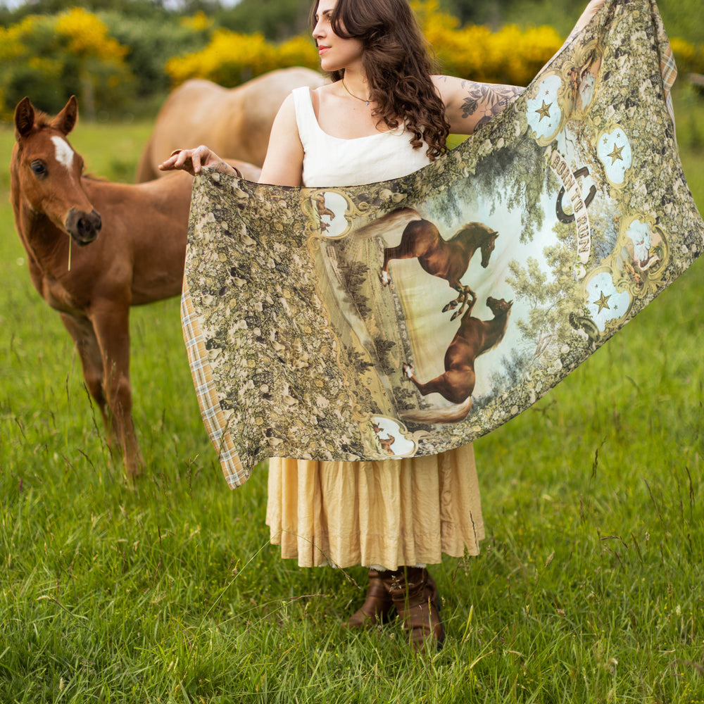 
                  
                    Model wearing a bamboo-viscose scarf made for everyday adventures with a whimsical print celebrating one's unbridled spirit of adventure - Market of Stars
                  
                