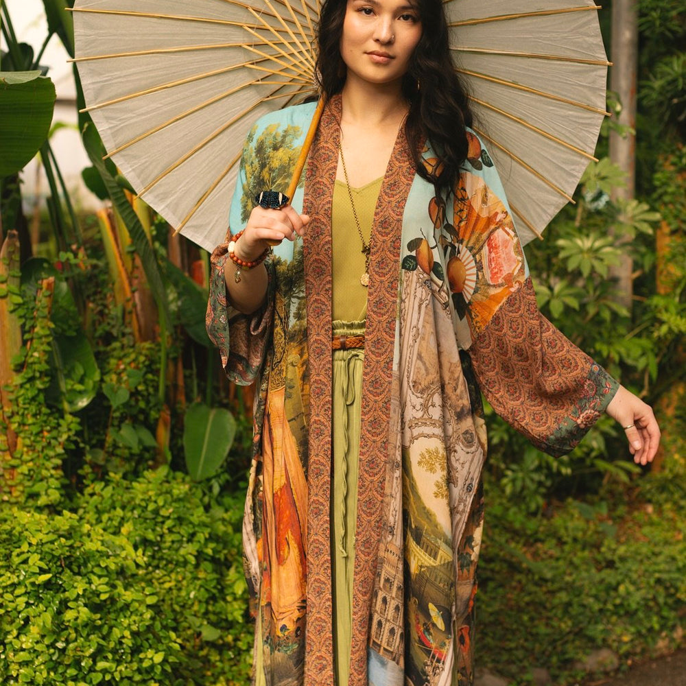Model wearing Peace, Wine & Sunshine Bohéme Slip Dress featuring botanical collages and playful peace, wine and sunshine lettering on the hem – Market of Stars.