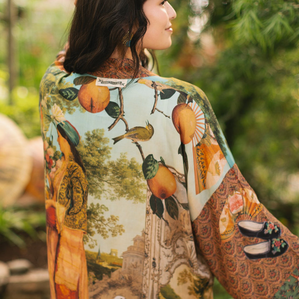 Model wearing Peace, Wine & Sunshine Bohéme Slip Dress featuring botanical collages and playful peace, wine and sunshine lettering on the hem – Market of Stars.