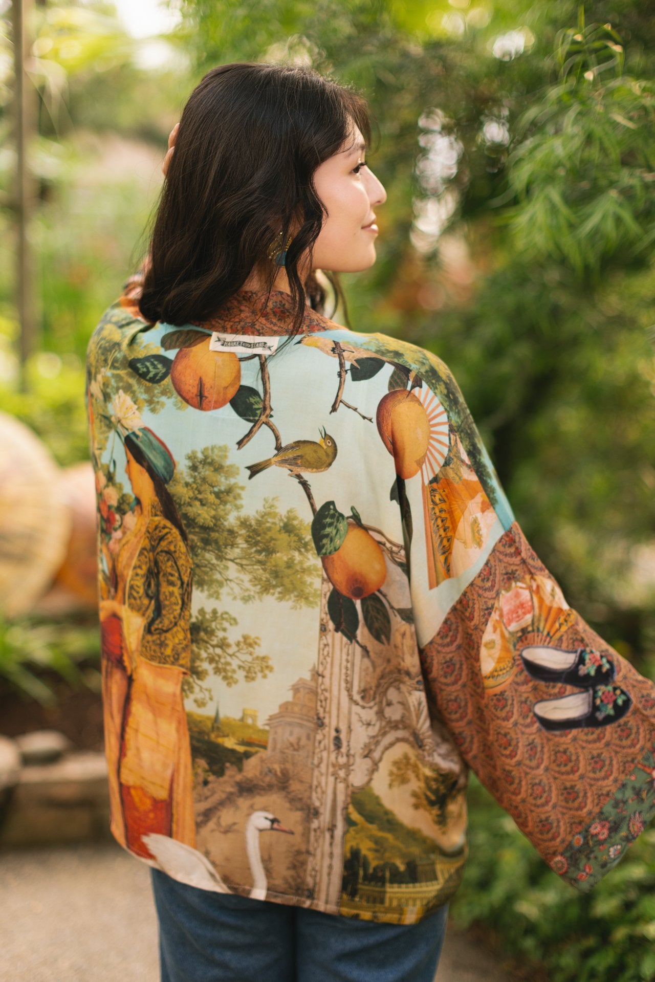 Model wearing Peace, Wine & Sunshine Bohéme Slip Dress featuring botanical collages and playful peace, wine and sunshine lettering on the hem – Market of Stars.