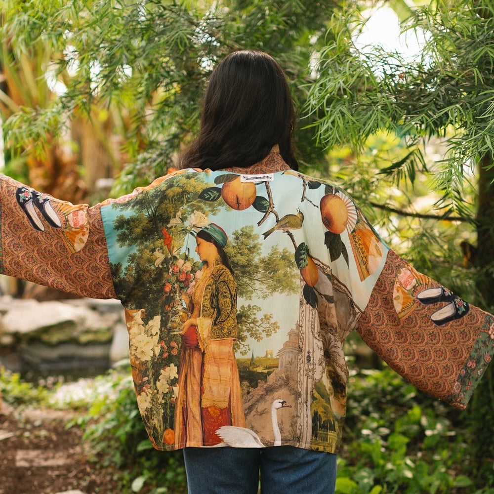 Model wearing Peace, Wine & Sunshine Bohéme Slip Dress featuring botanical collages and playful peace, wine and sunshine lettering on the hem – Market of Stars.
