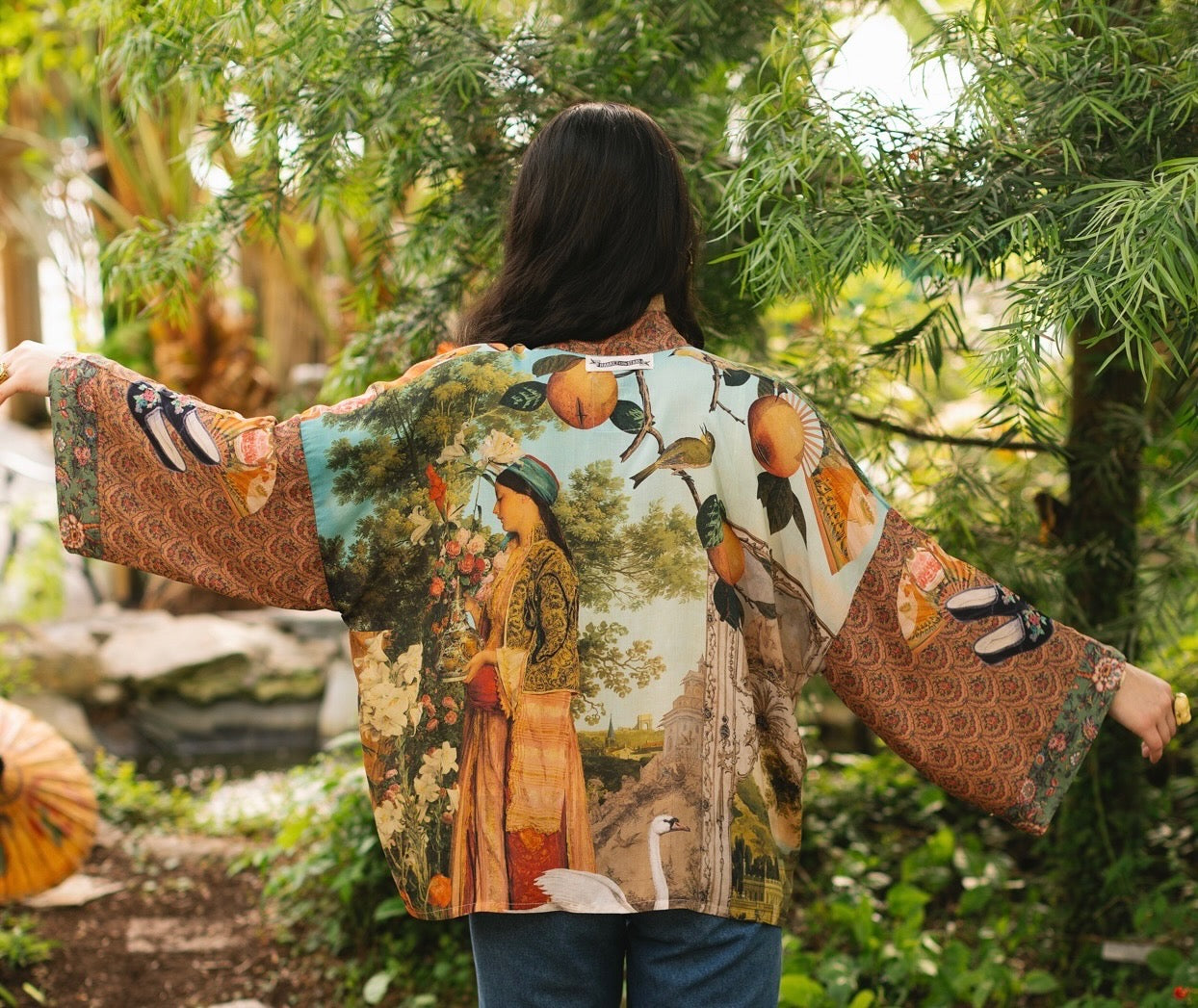 Model wearing Peace, Wine & Sunshine Bohéme Slip Dress featuring botanical collages and playful peace, wine and sunshine lettering on the hem – Market of Stars.