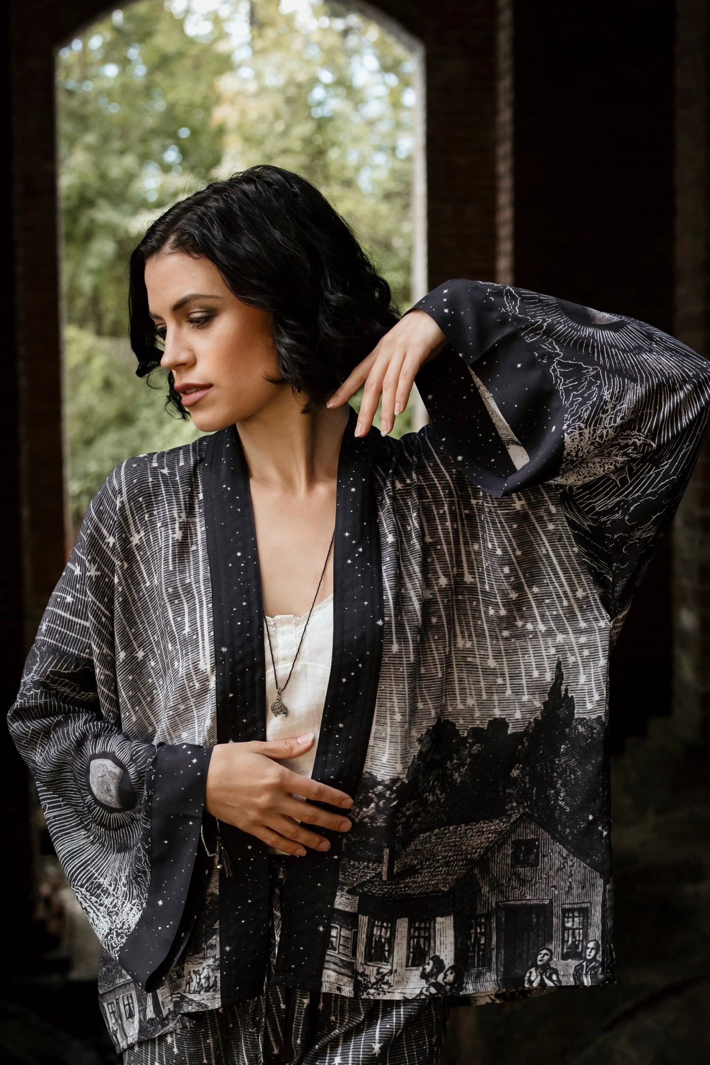 Model wearing our Stargazer cropped kimono featuring an antique engraving of a meteor shower and moonlit astronomy imagery – Market of Stars