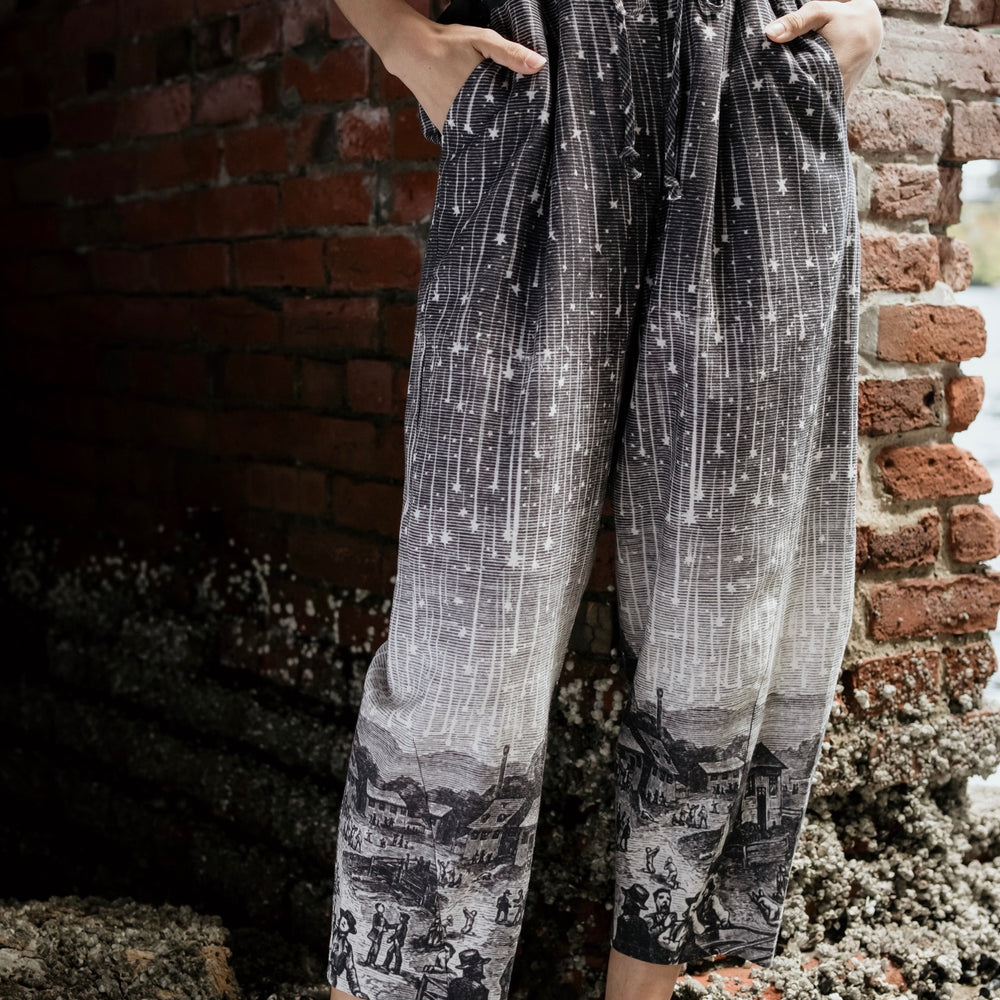 Model wearing Peace, Wine & Sunshine Bohéme Slip Dress featuring botanical collages and playful peace, wine and sunshine lettering on the hem – Market of Stars.